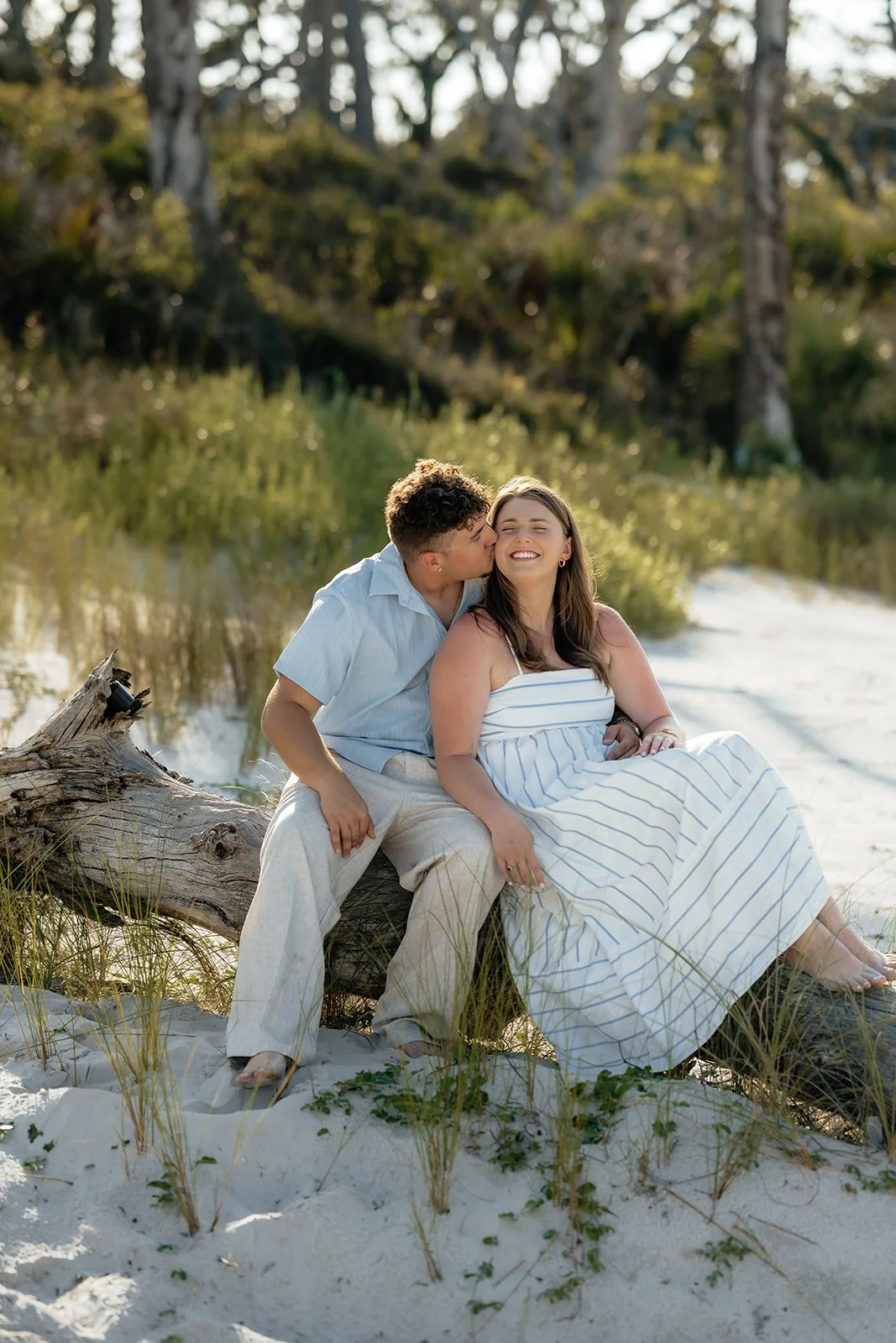 a couple kissing on the beach 