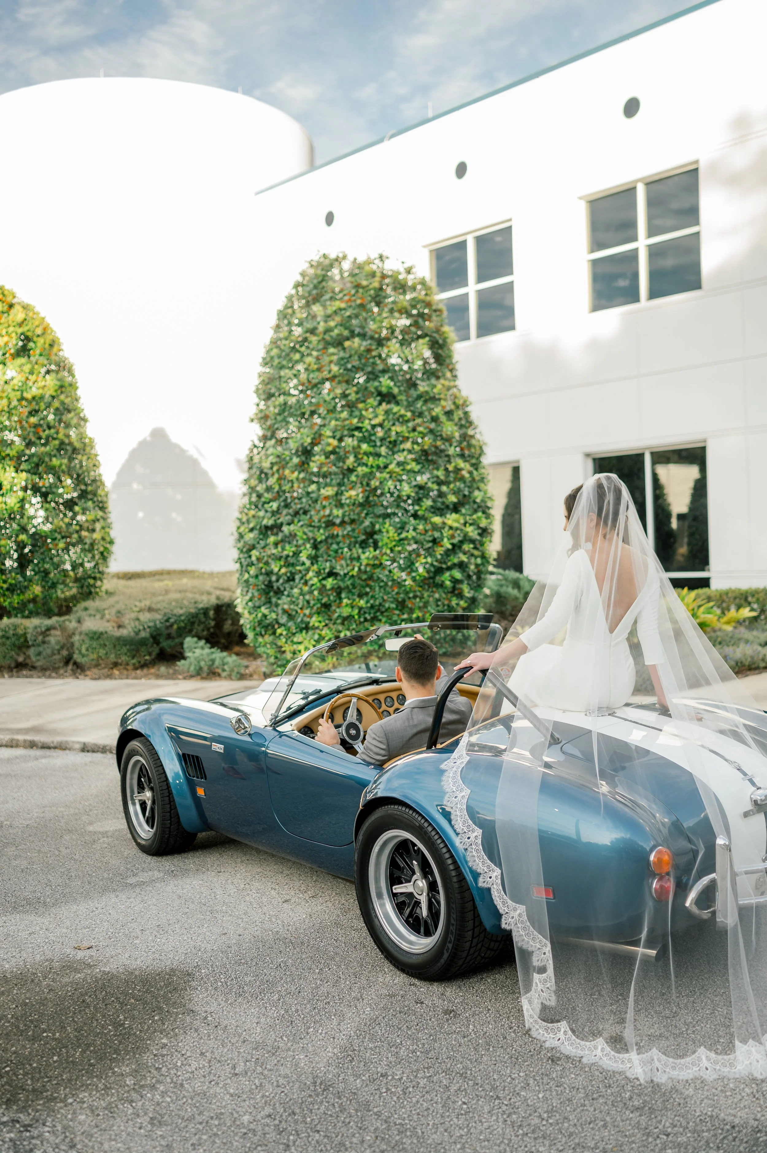 Couple at wedding in getaway car at Deerwood Castle in Jacksonville, FL
