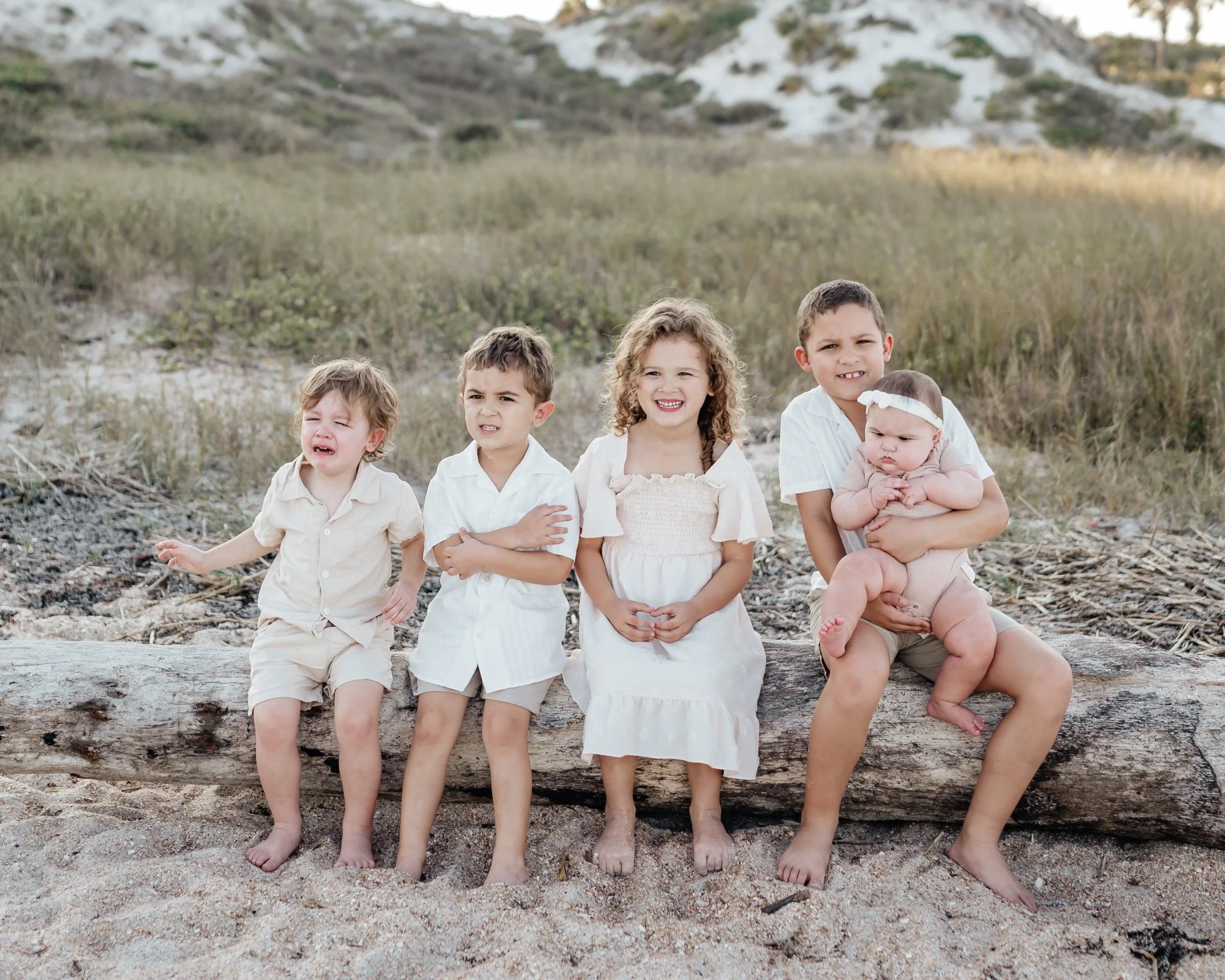 5 kids sitting at the beach for family photos shot by hailee Cataldi photo