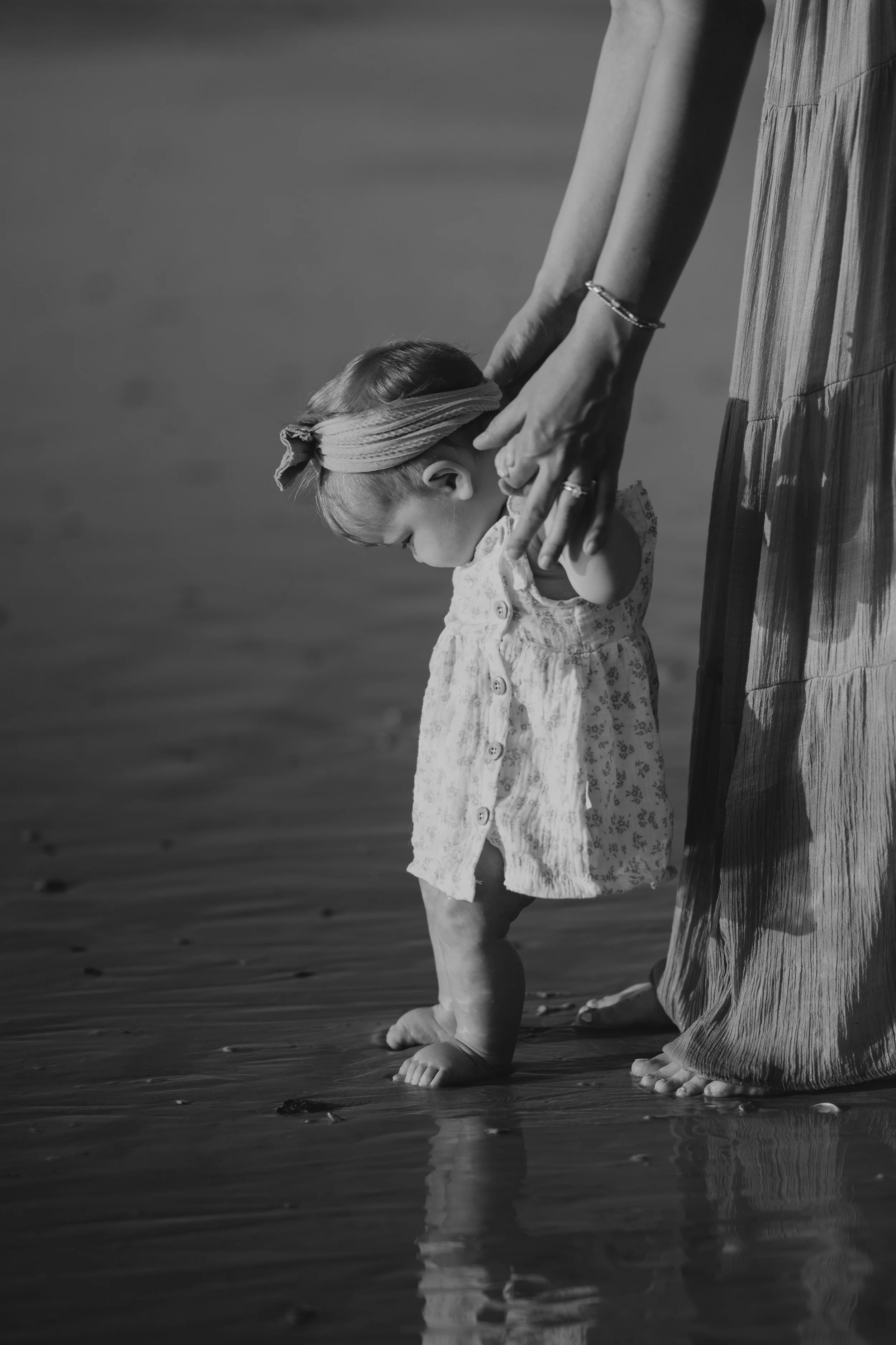 small child standing in the sand at the beach in Jacksonville Florida