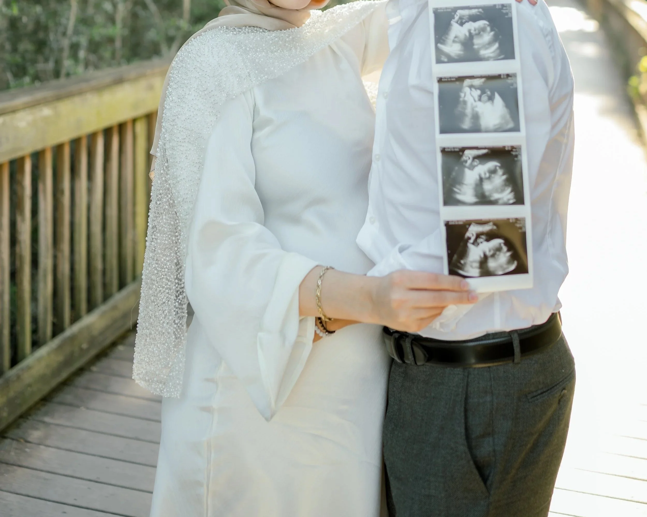 a pregnant woman holding her ultrasound photo shot by hailee Cataldi photo