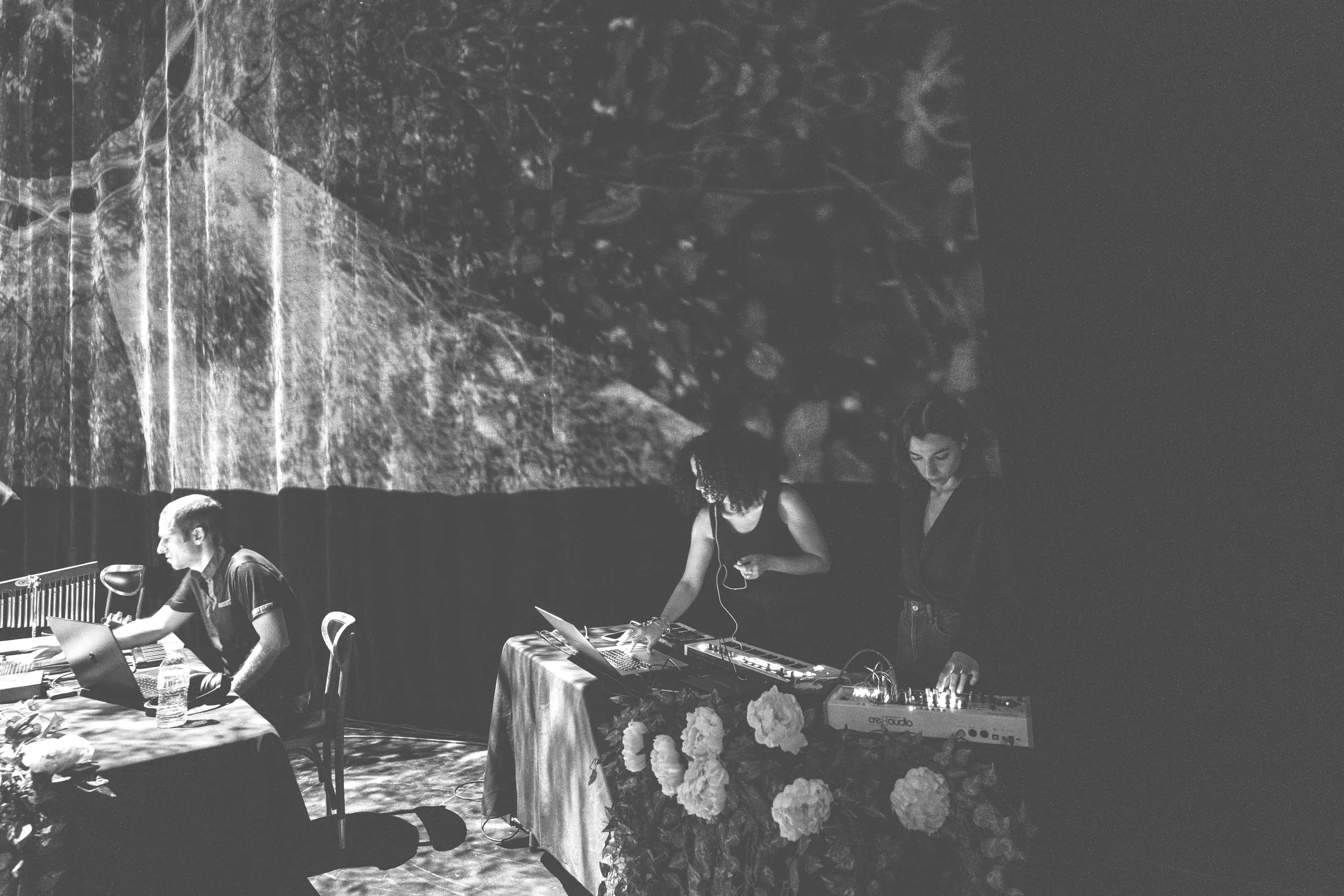 ONNA founders and artists performing at the performance of 'The Secret Symphony of Sounds' in Artpark, with visual projections illuminating the backdrop.