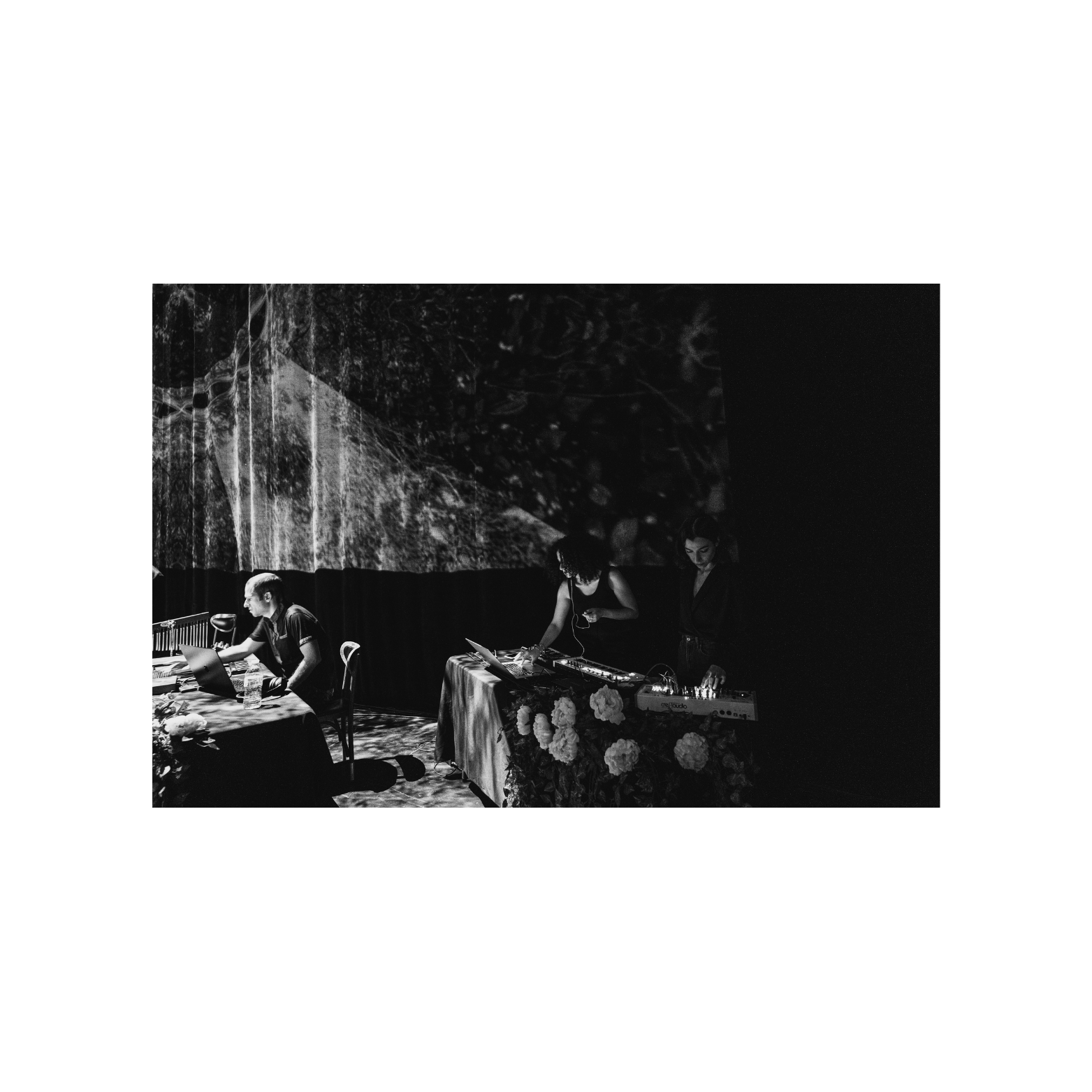 Musicians performing alongside the orchestra at Art Park performance with organic materials and nature projections.