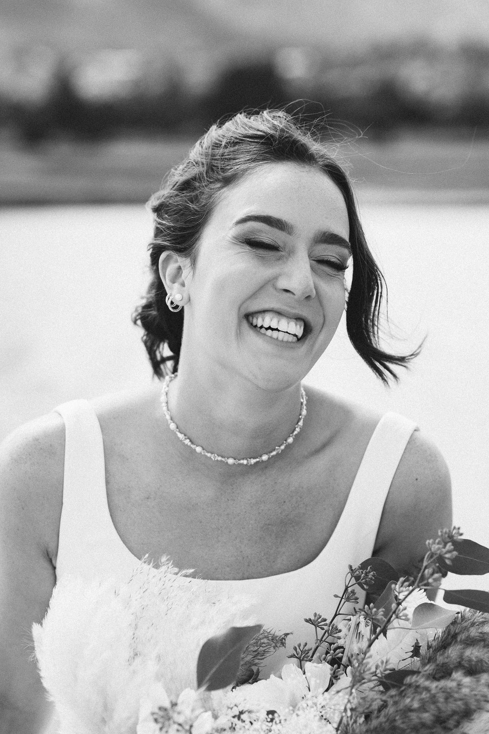  candid photo of a bride laughing on her wedding day 