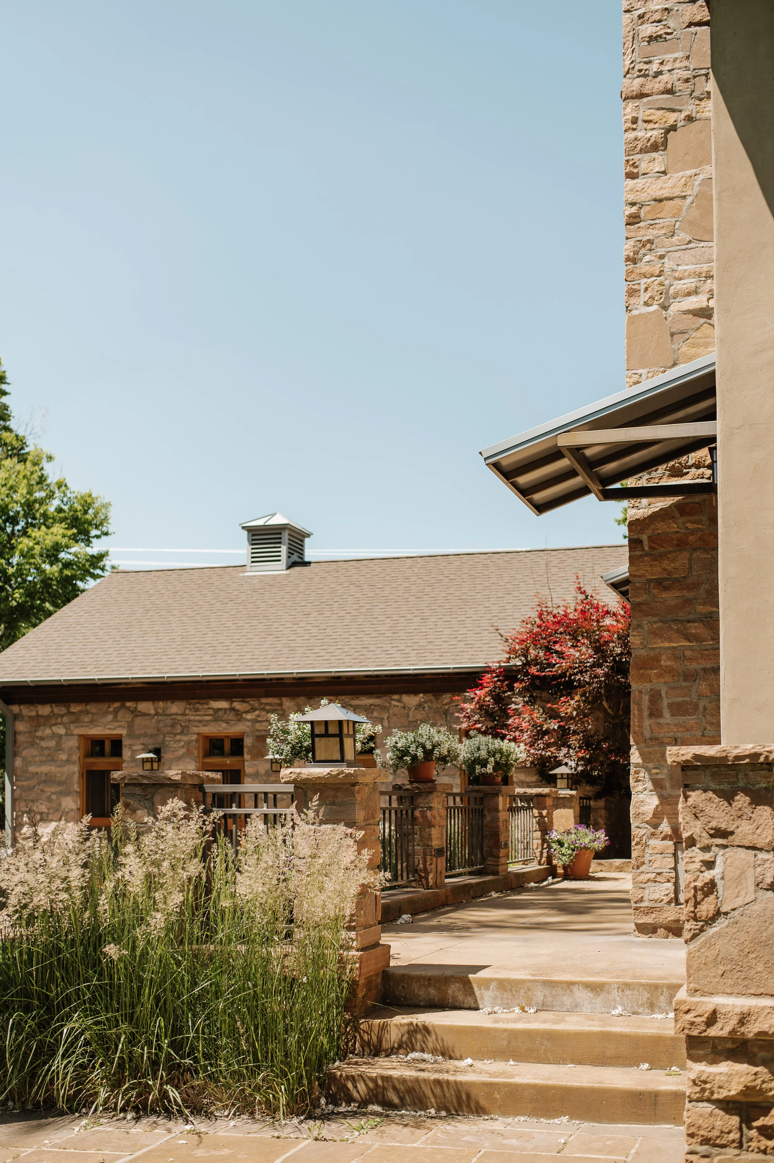 architectural photo of a flagstone house with landscaping