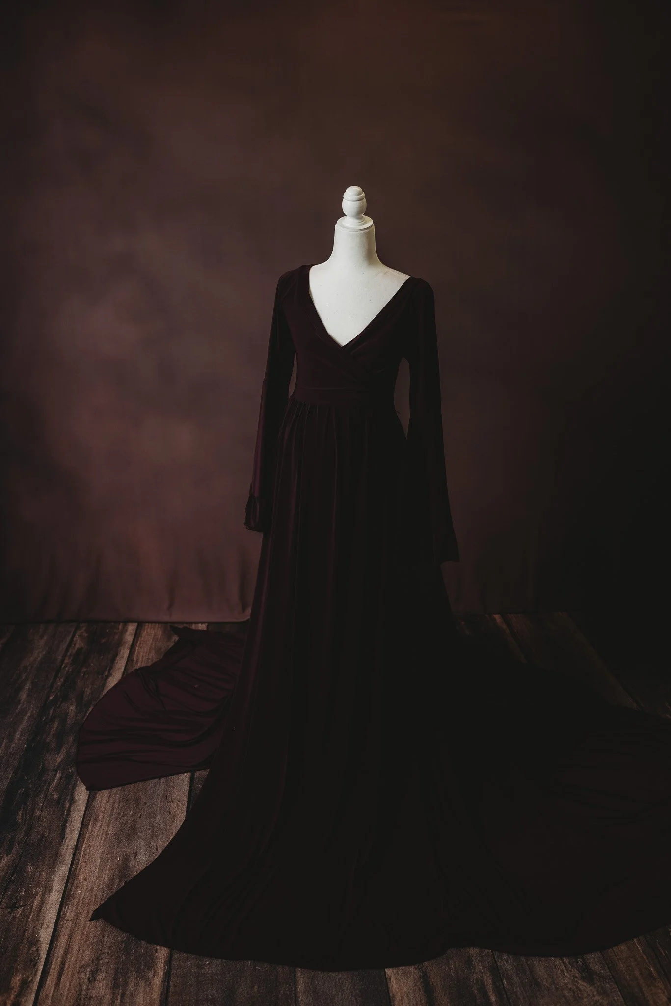 Elegant black dress on a mannequin, dark background