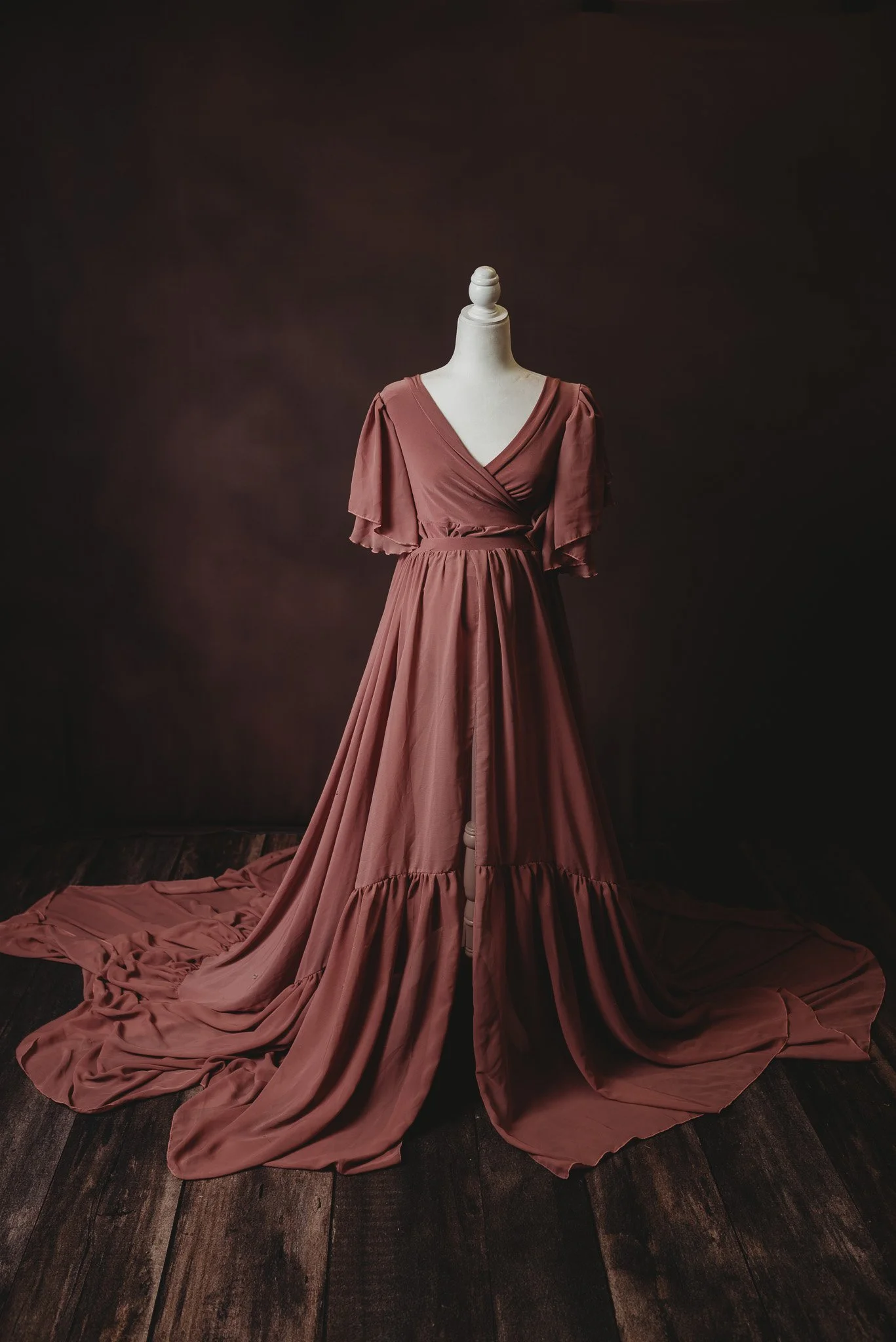 Long mauve dress on mannequin in studio setting