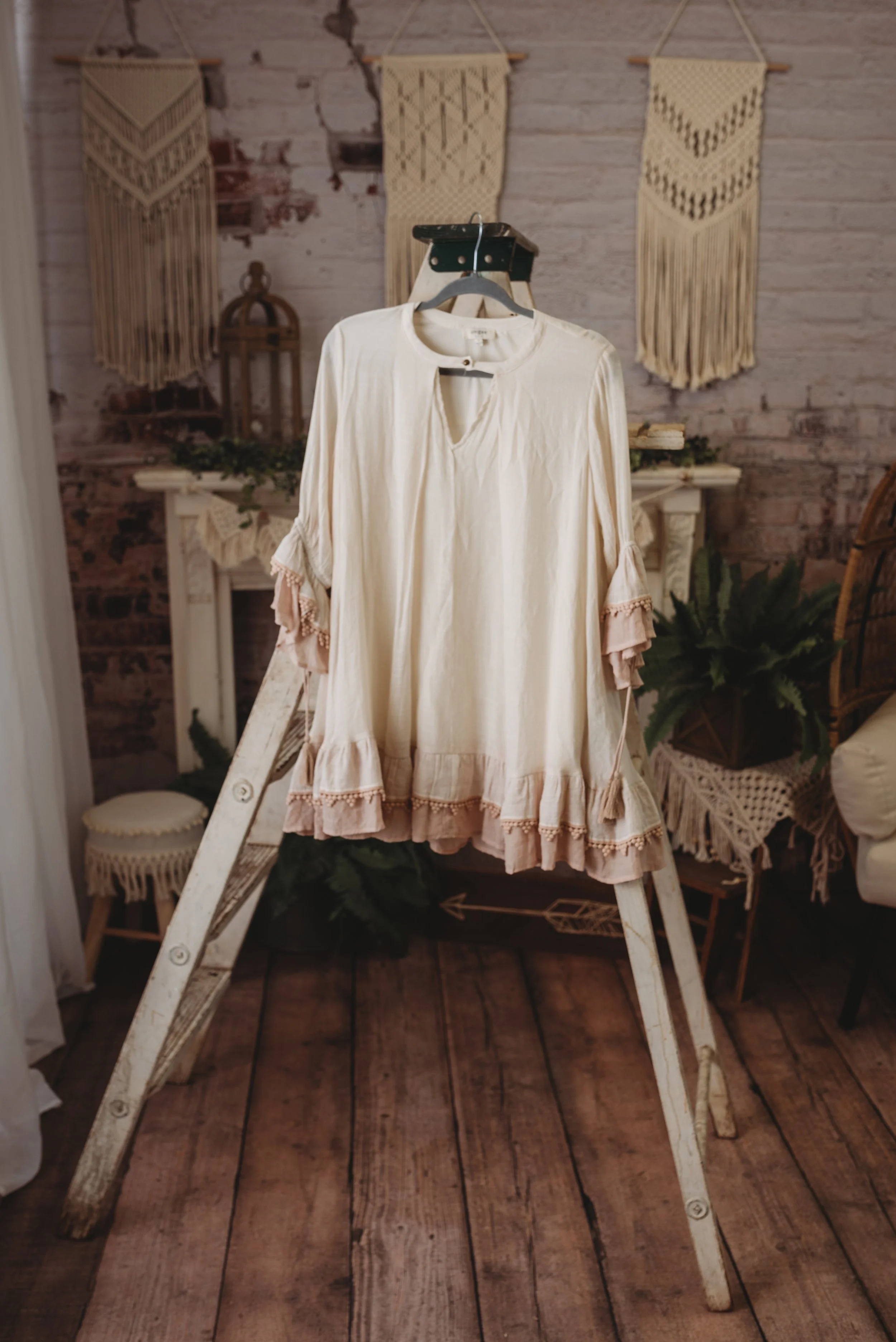 Vintage cream blouse on a ladder stand, bohemian decor