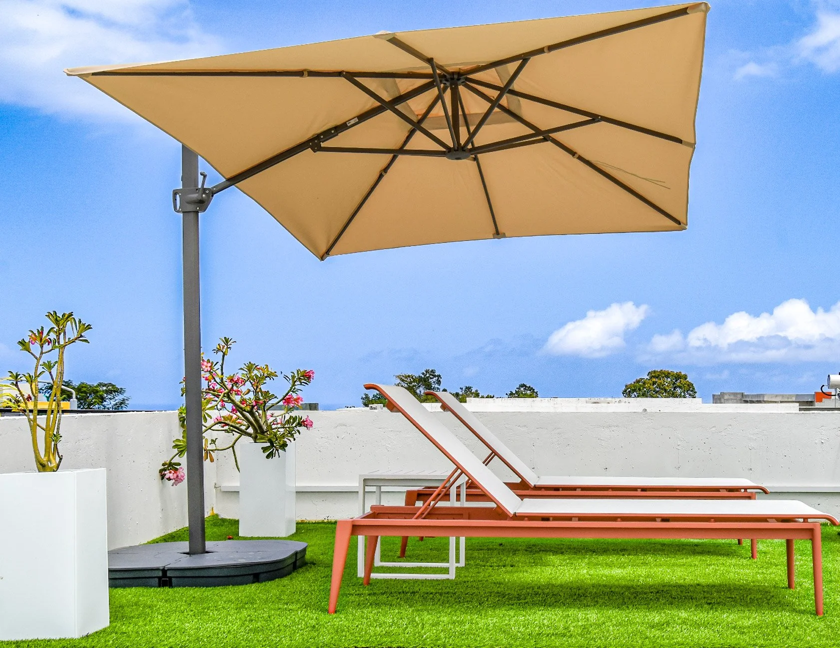 Private rooftop terrace at Luxe Oasis villa in Ocho Rios, Jamaica, featuring a hot tub, comfortable outdoor lounging areas, and tropical surroundings.