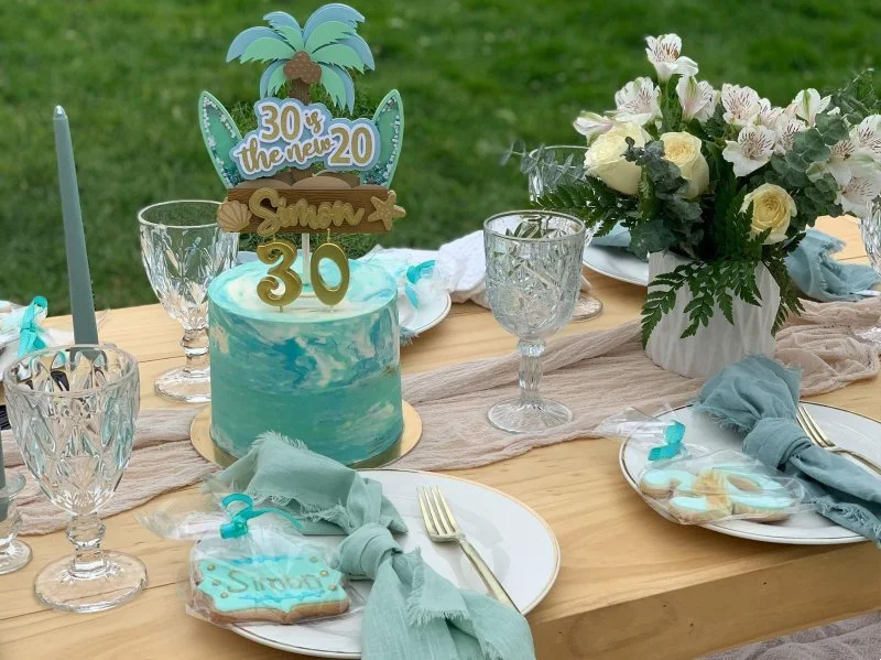 Custom celebration cake displayed at a private picnic at Luxe Oasis in Ocho Rios, Jamaica