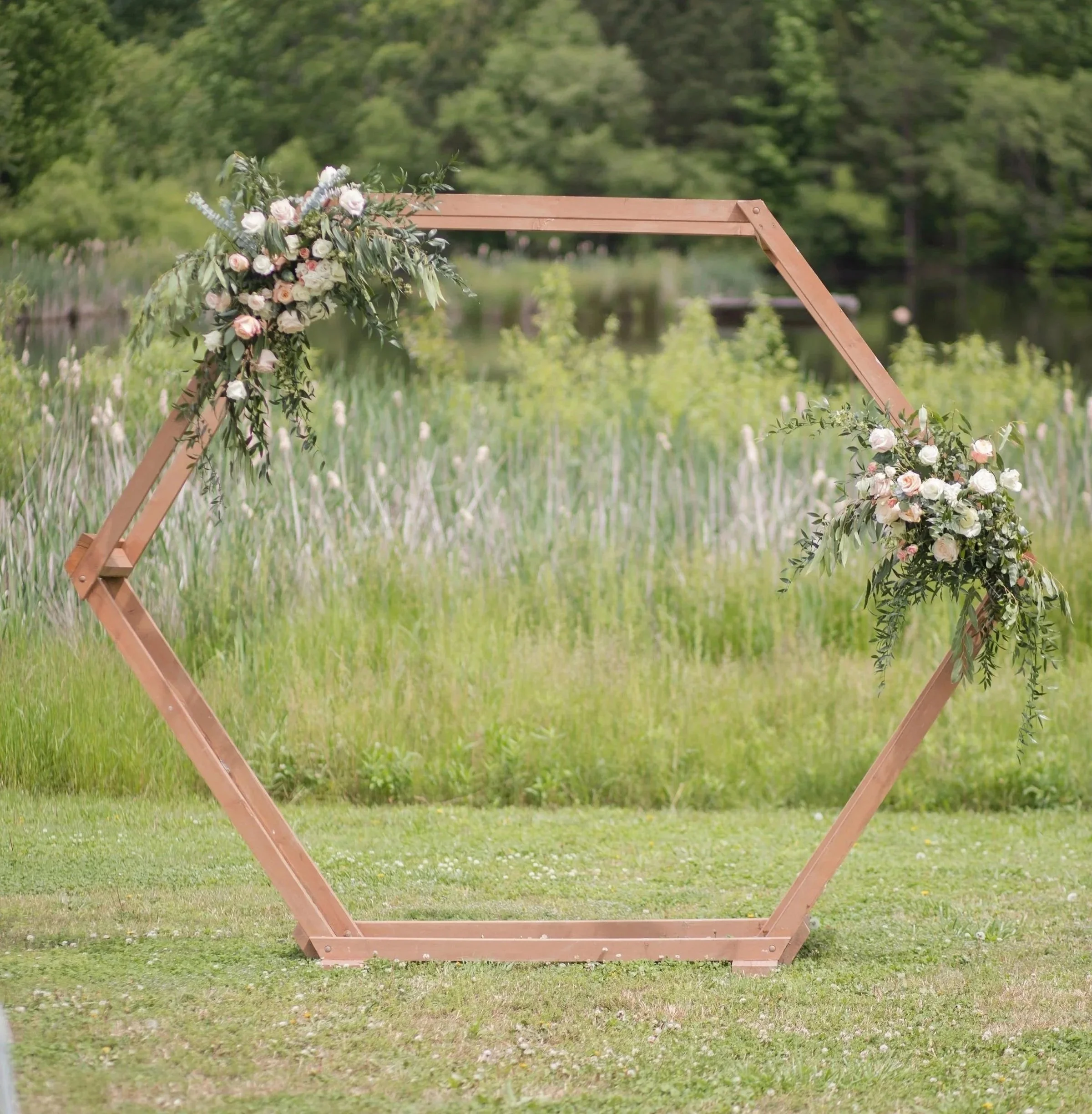 Aidan and Eric hexagonal arbor by the pond.jpg