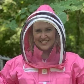 woman in pink bee suit