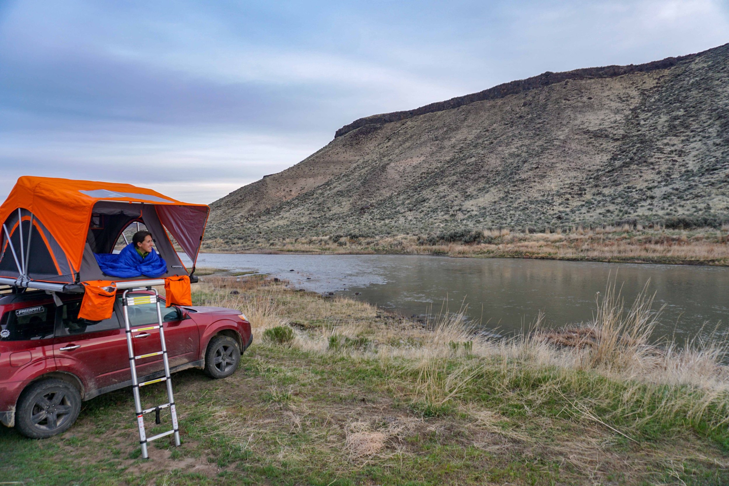 emily-sitting-in-a-tent-on-the-owahee-river-subaru-camper-two-dusty-travelers.jpg