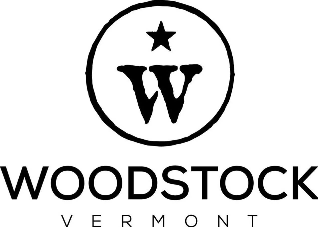 Logo of Woodstock Vermont featuring a stylized letter W within a circle and a star above it.