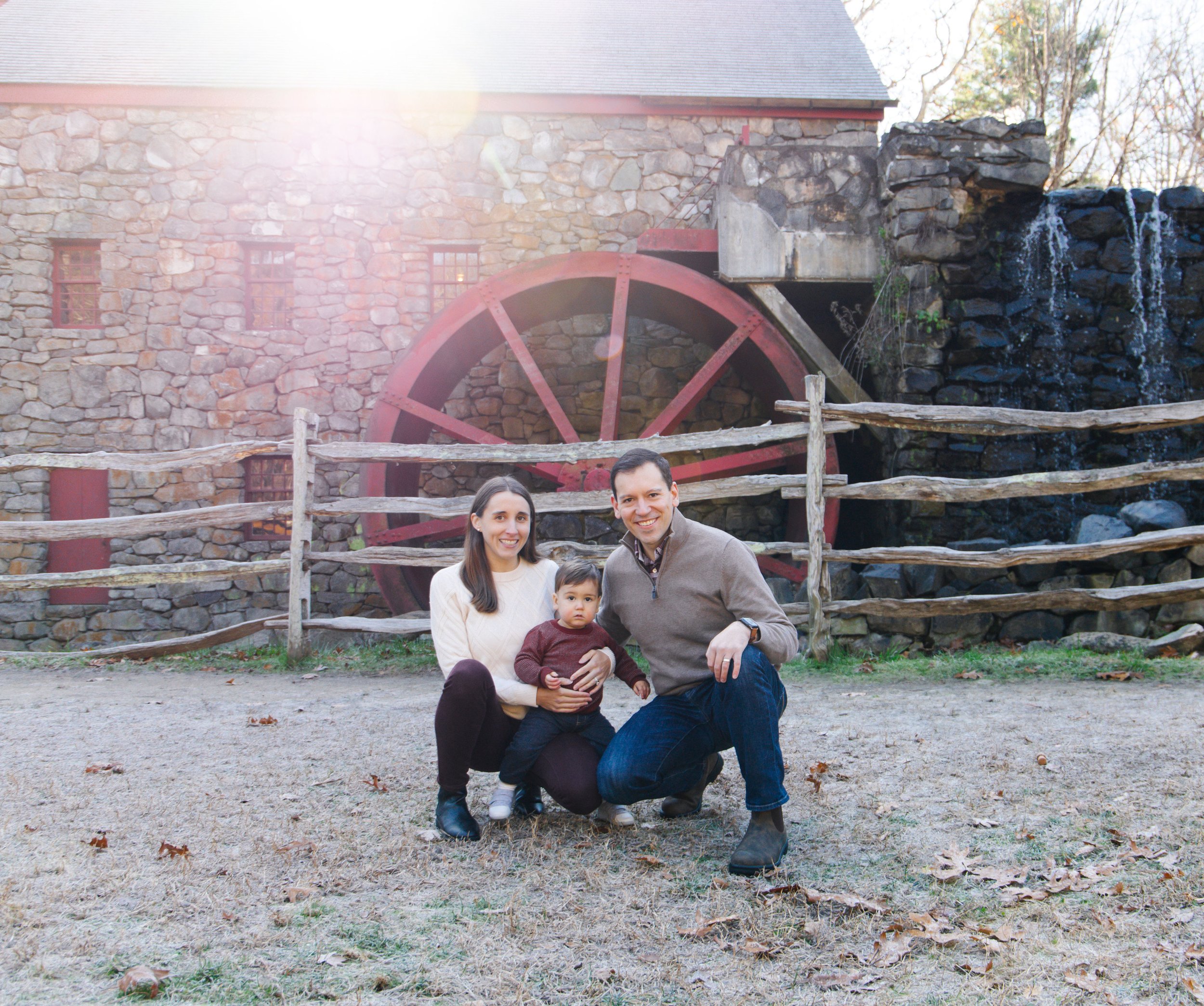 A family of three in front of a mill