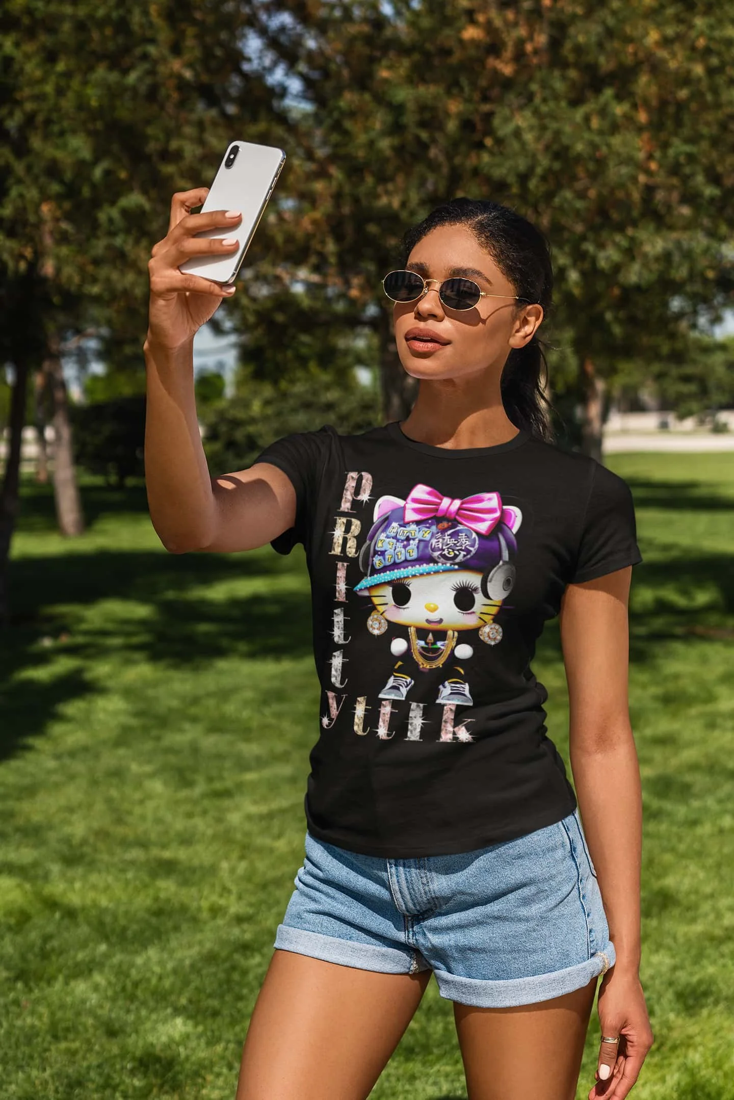 Black Pretty Cat t-shirt mockup of a woman taking a selfie at a park @jellybzz.com