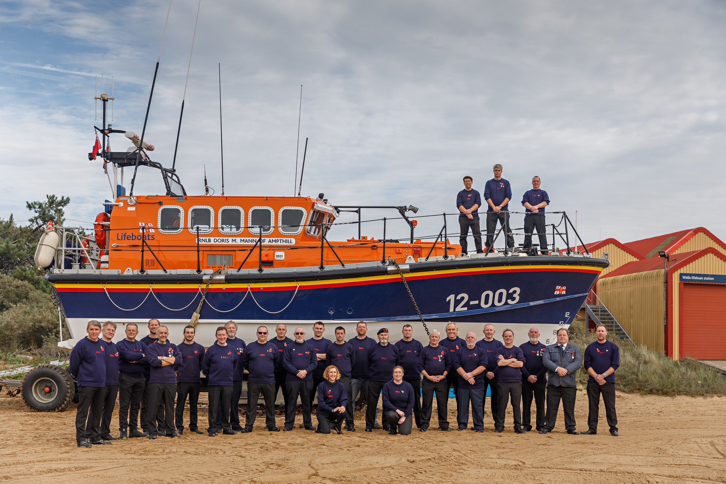  Wells RNLI crew, shore crew and station officers in front of the Mersey for the last time. 