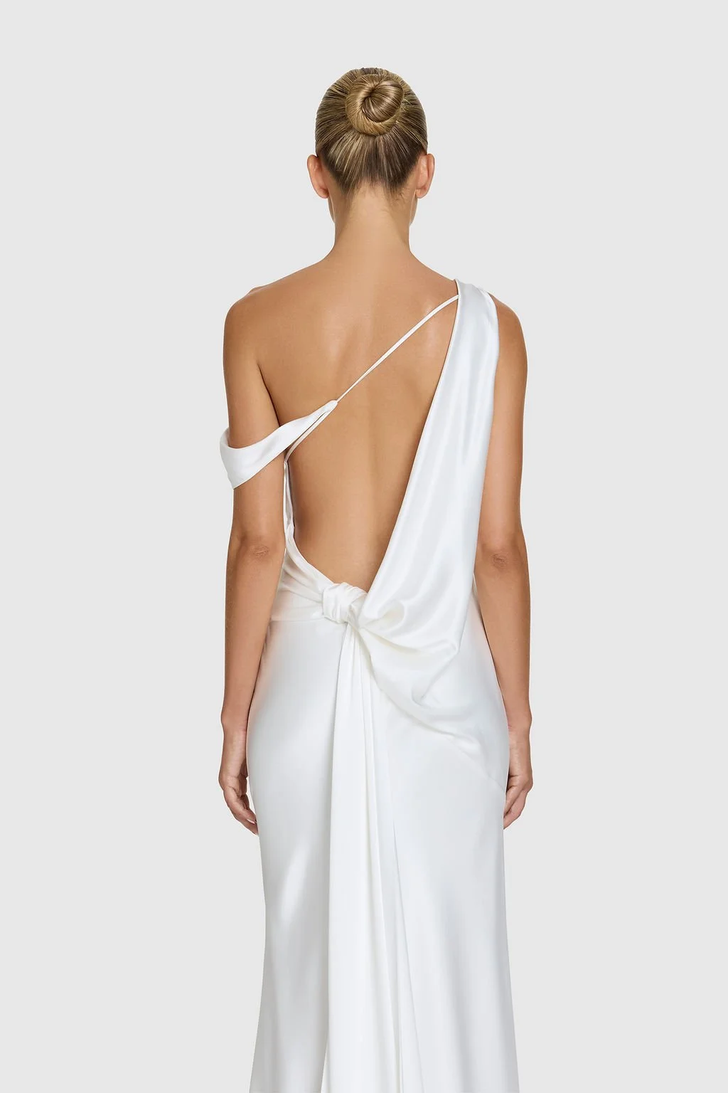 Effortlessness takes the lead in KYHA Bride Arlo. Cut on the bias, liquid double satin falls naturally over the body, delivering nonchalant energy with a distinctly modern edge. A clean, minimal off-shoulder front allows the open back to take centre 