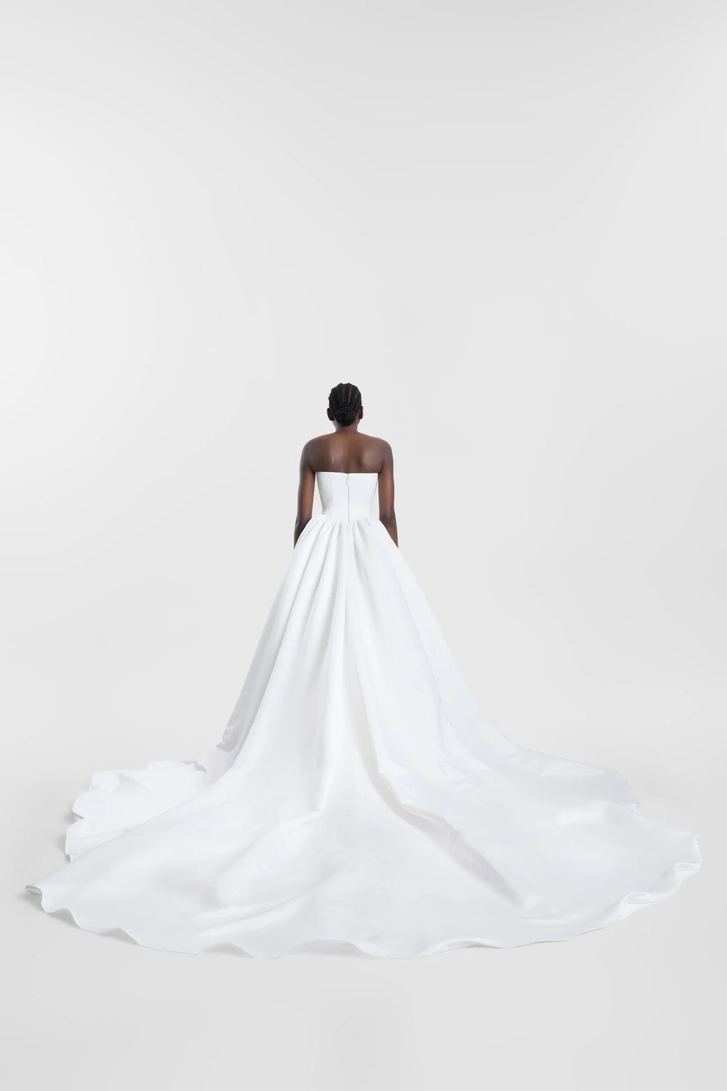 Clean lines, dramatic proportions and more than a touch of je ne sais quoi define KYHA Bride Cleo. A minimalist reinvention of the traditional ballgown, Cleo's clean, strapless bodice is defined by a modern straight neckline and unexpected low-dipped