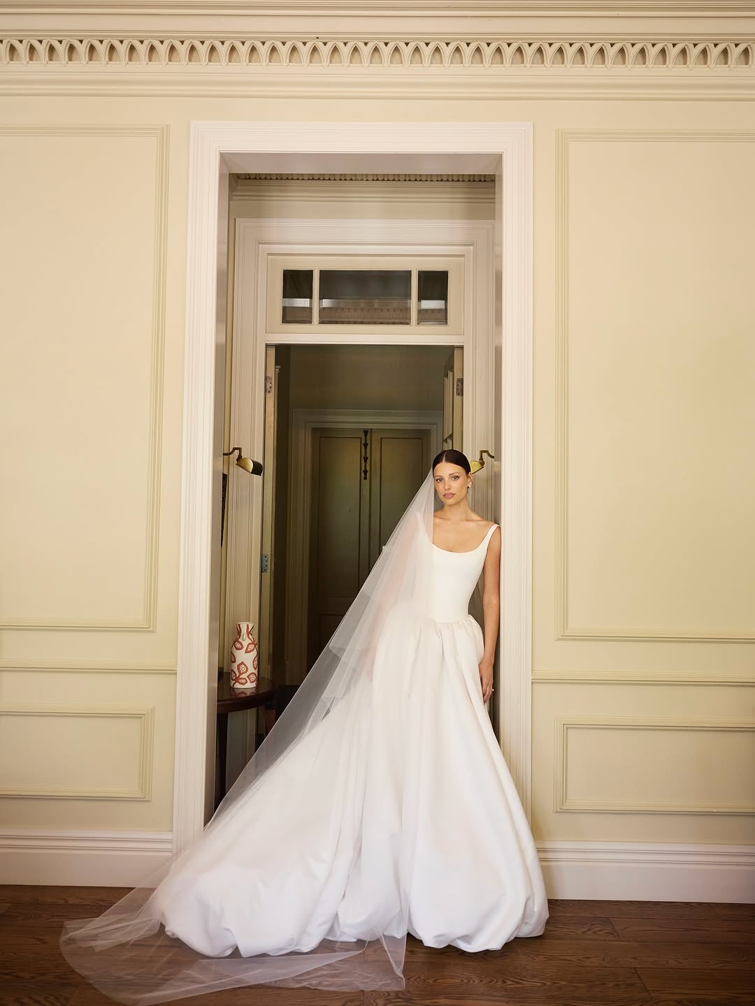 You’re a powerful presence in KYHA Bride Emery. A fresh take of a timeless silhouette, Emery balances sculpted precision with cloud-like airiness. A scoop-neck, corseted bodice flows into a gathered skirt, embodying KYHA’s signature play on structure