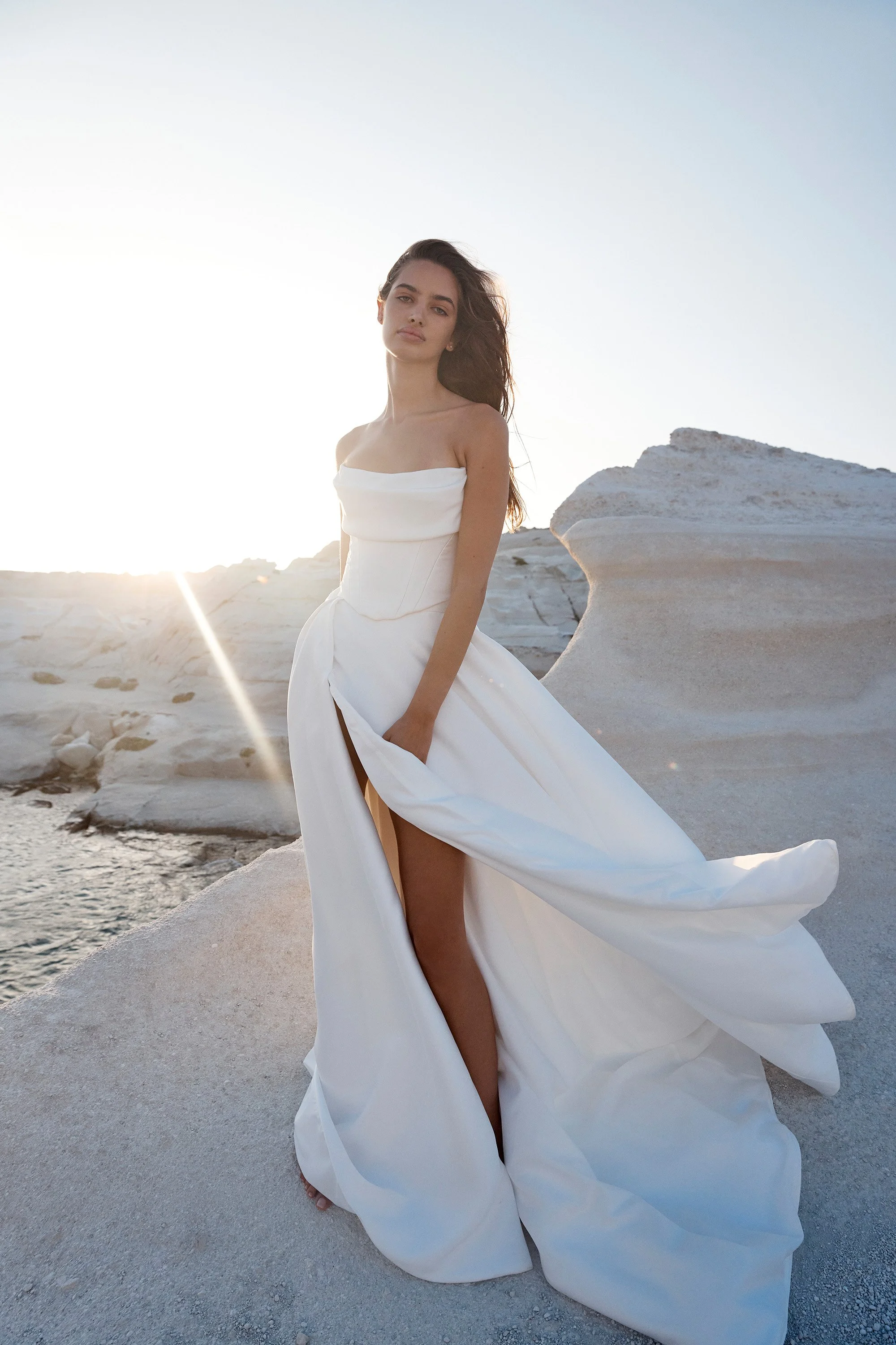 Be followed by a train of lustrous duchess satin every step you take with the KYHA Bride Milford Skirt. With a fitted waistband and full pleated skirt with a modern split, the Milford Skirt can be styled as an overskirt to raise the drama of any look