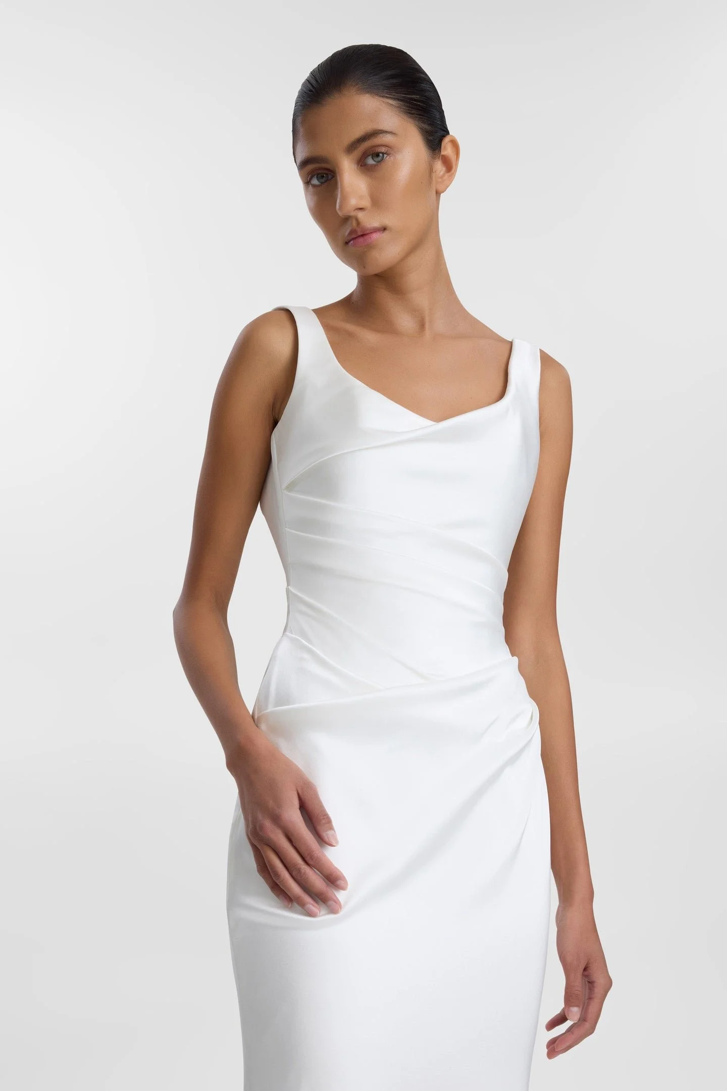 A love letter to 90s minimalism, KYHA Bride Llume is a structured take on a classic slip, Llume masters the art of draping, using organic folds across the scoop neckline, waist and hip, both bouncing light and accentuating the female form. Crafted fr