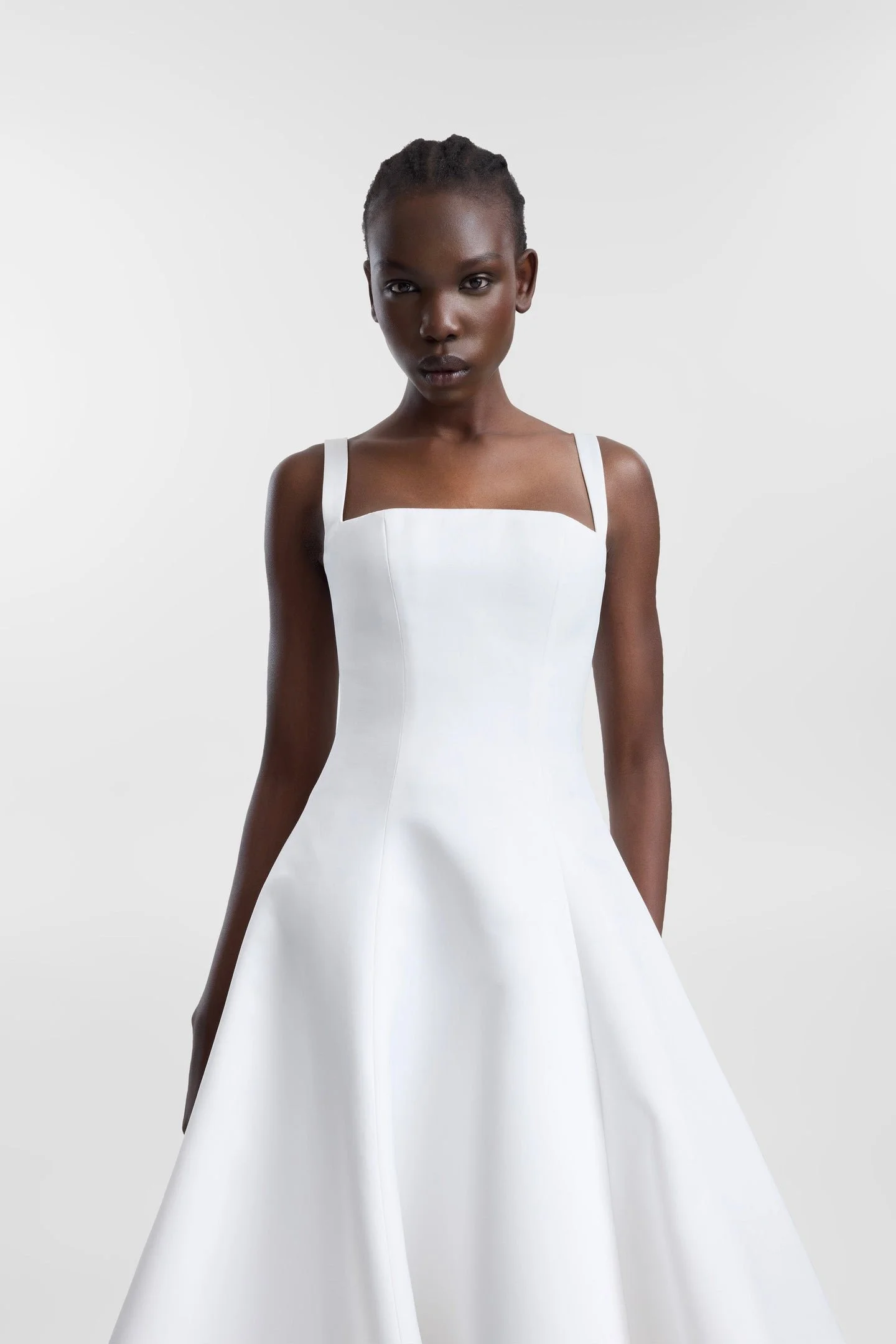 Minimalist moments served via KYHA Bride Holloway. Imagined crafted in bright ivory duchess satin, Holloway is brought to life through its square neckline and soft-but-architectural A-line silhouette . It features a strapped, corseted bodice and skir