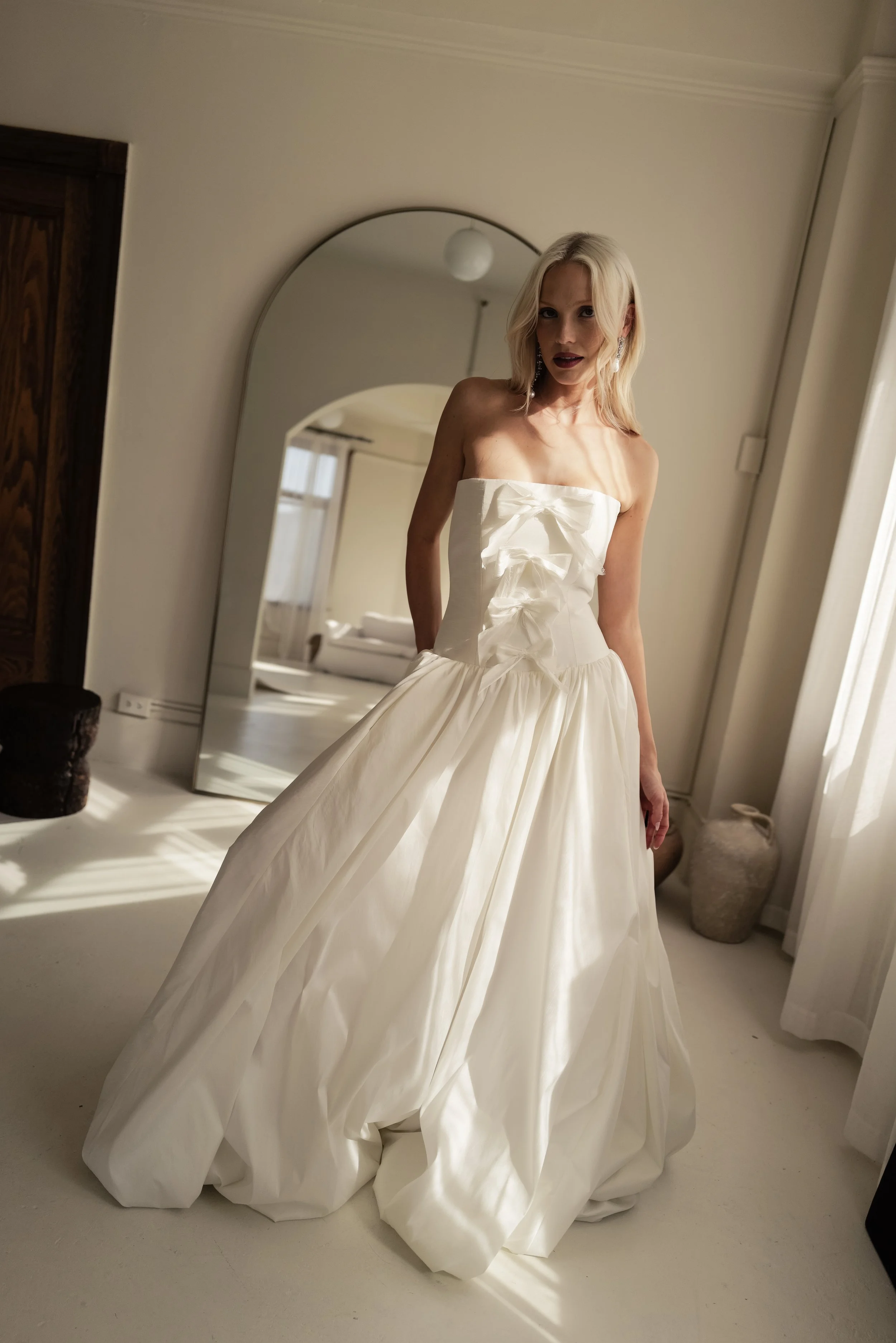 The & For Love Bridal Antoinette gown is a bold fashion-forward statement piece designed for the bride who wants to turn heads. With its striking silhouette, edgy couture details, and expertly crafted structure, this gown blends high-fashion attitude