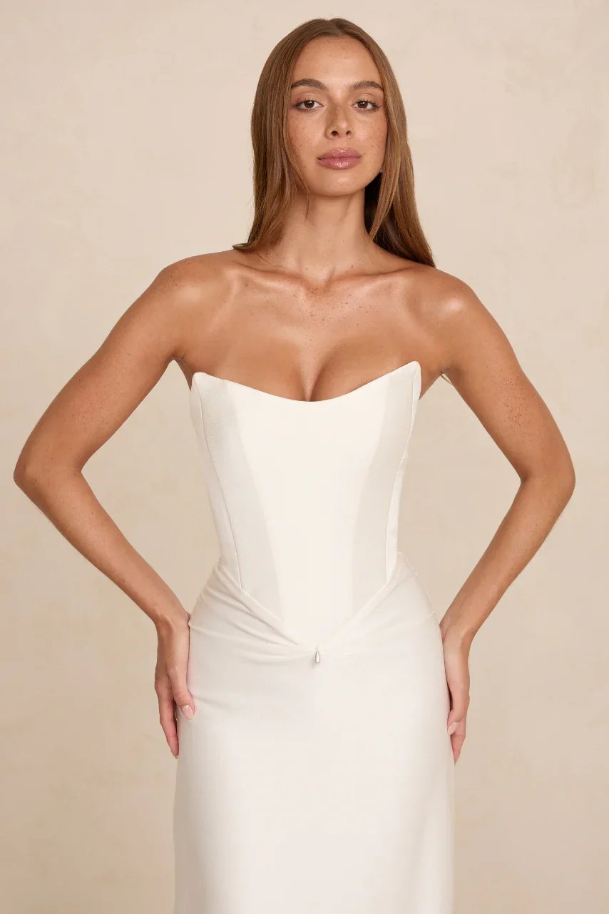 The MWL Natalie is crafted from two layers of Crepe Satin with a fluid drape and soft sheen. A cinched scooped bodice defines the waist, while a pinched front and illustrious fabric creates an exceptional bridal look. Natalie will be available at Hal