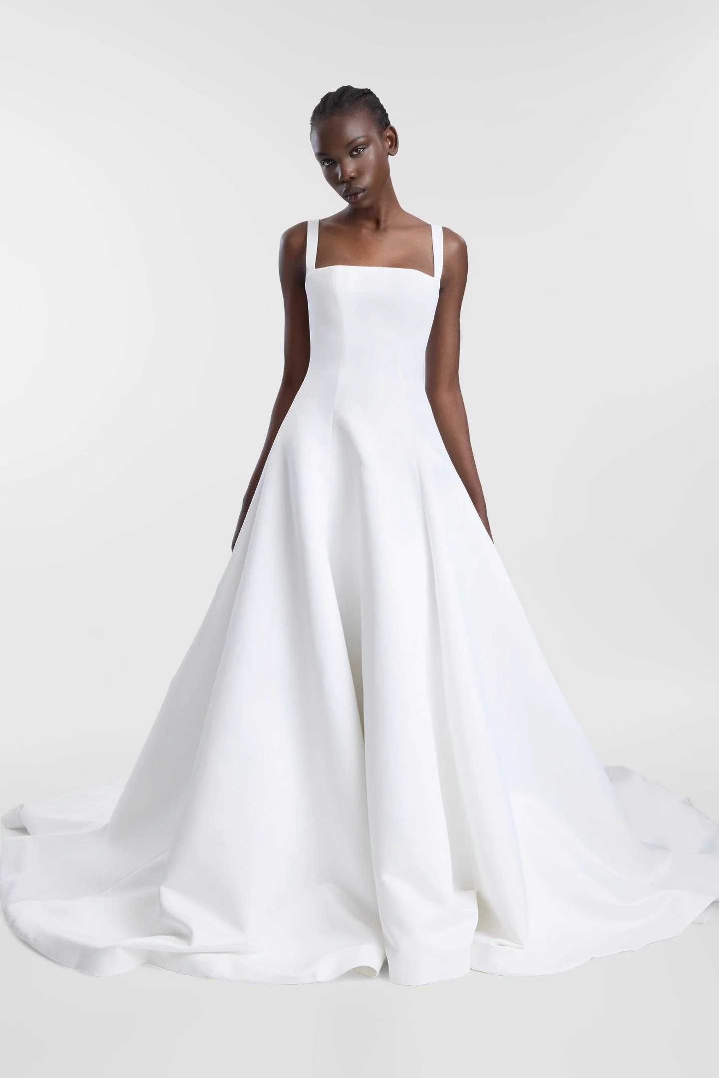 Minimalist moments served via KYHA Bride Holloway. Imagined crafted in bright ivory duchess satin, Holloway is brought to life through its square neckline and soft-but-architectural A-line silhouette . It features a strapped, corseted bodice and skir