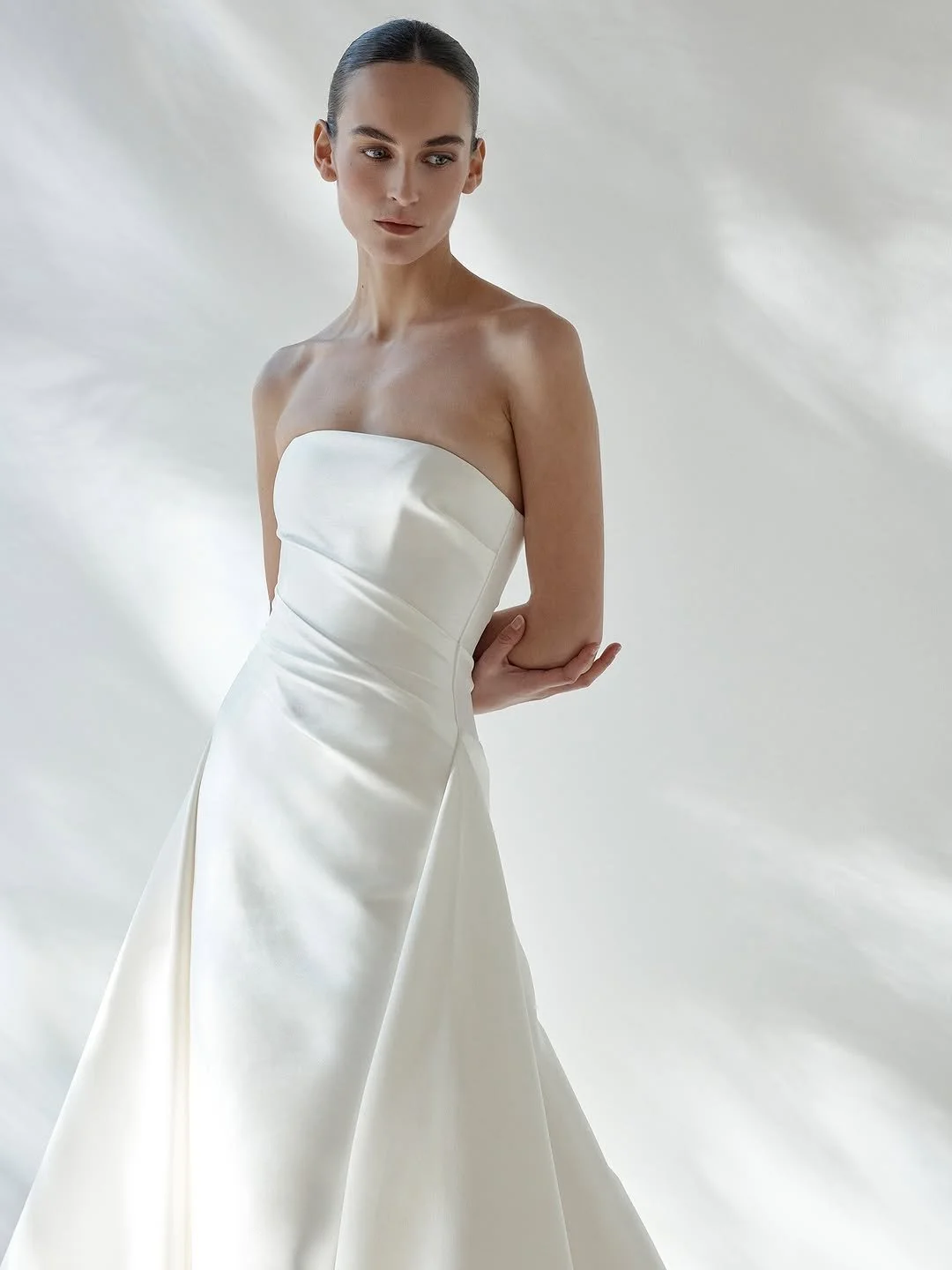 DETAILS - fit check with KYHA bride Ellery? expect minimalism with maximum impact. Ellery delivers a flawless fit thanks to its highly structured bodice, a deliberate contrast to its pared back, straight neckline and effortless drape detail. crafted 