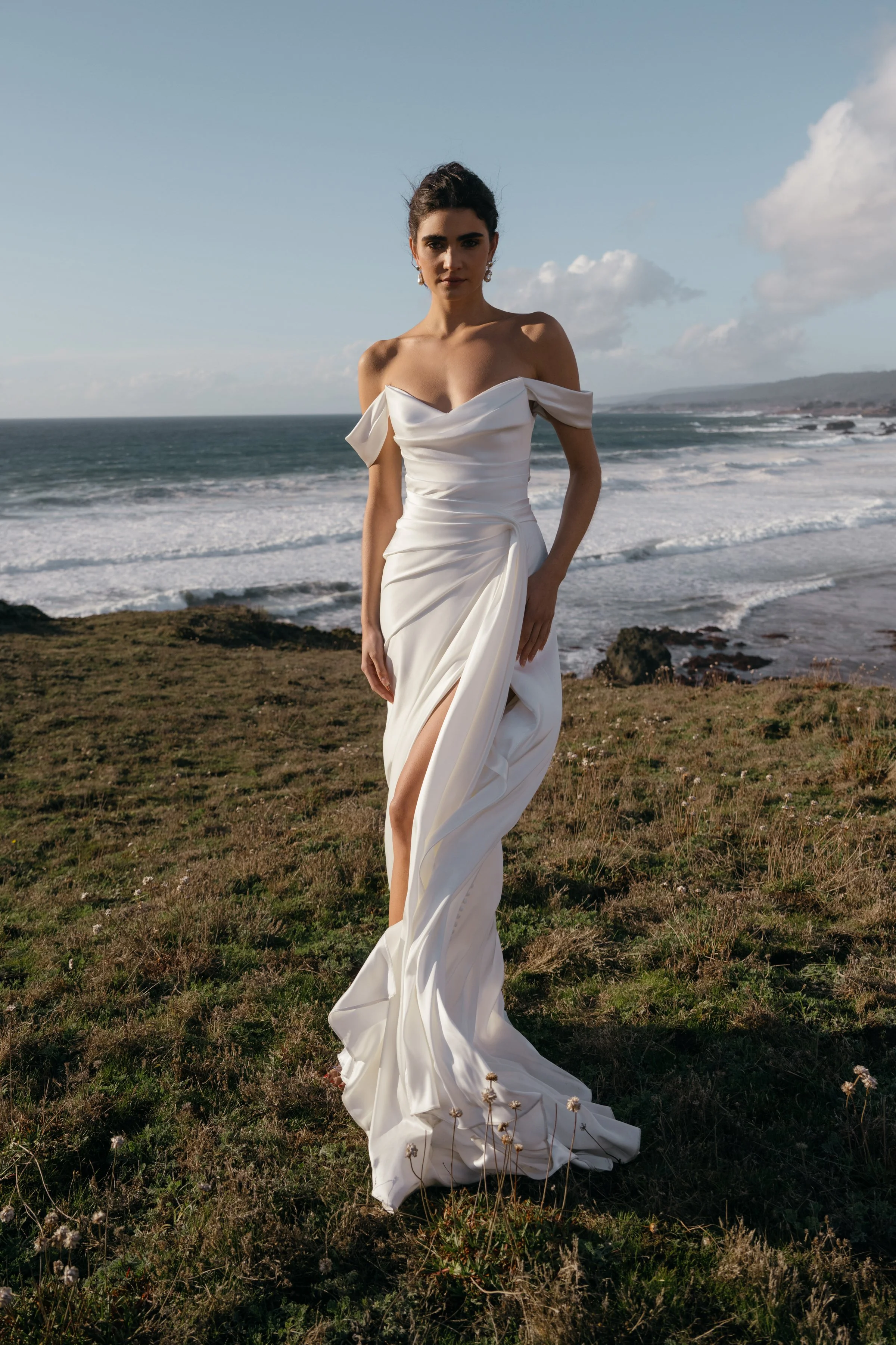 The Jenny Yoo Lana gown is a refined satin wedding dress cut in luminous Barcelona satin with elegant pleating and draping that flatters the figure, and it stands out for its versatile styling with removable long sleeves and optional sash sleeves tha