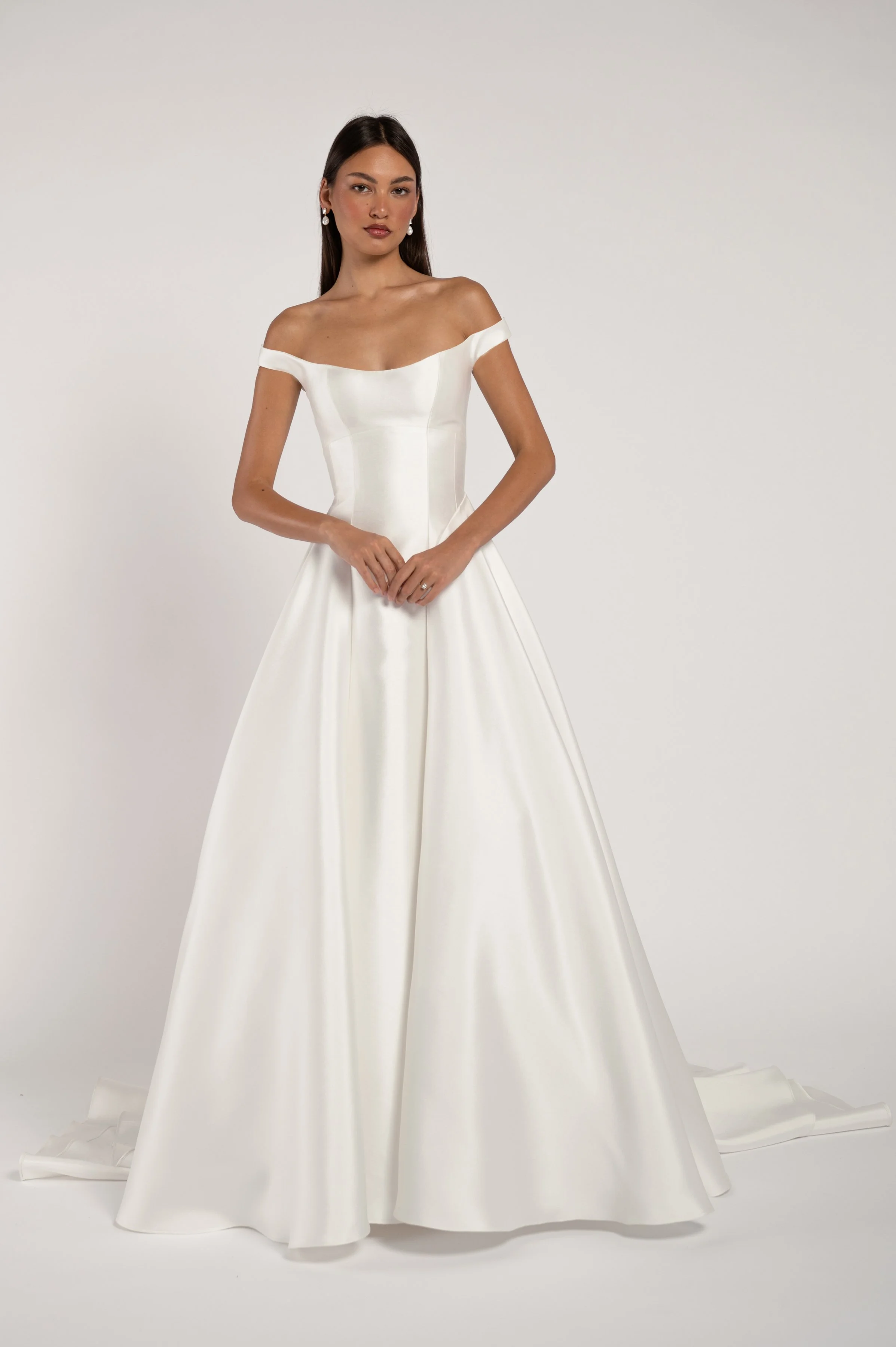 The Jenny Yoo Bridal Alyne gown is a classic beauty. The corseted bodice wraps gracefully around your shoulders while the dramatic skirt adds romance and drama. Available at Halo & Wren Bridal.

Details
Sleek Mikado fabric
Fully boned bodice
Bust cup