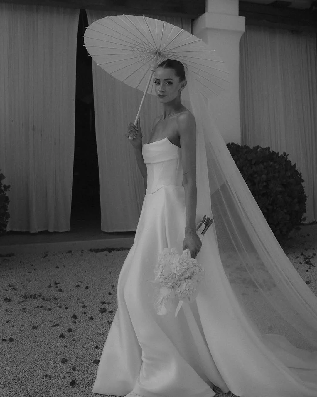 Be followed by a train of lustrous duchess satin every step you take with the KYHA Bride Milford Skirt. With a fitted waistband and full pleated skirt with a modern split, the Milford Skirt can be styled as an overskirt to raise the drama of any look