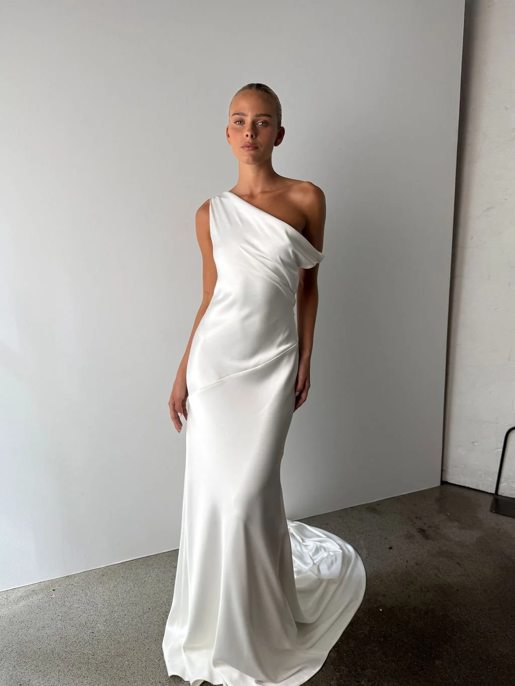 Effortlessness takes the lead in KYHA Bride Arlo. Cut on the bias, liquid double satin falls naturally over the body, delivering nonchalant energy with a distinctly modern edge. A clean, minimal off-shoulder front allows the open back to take centre 