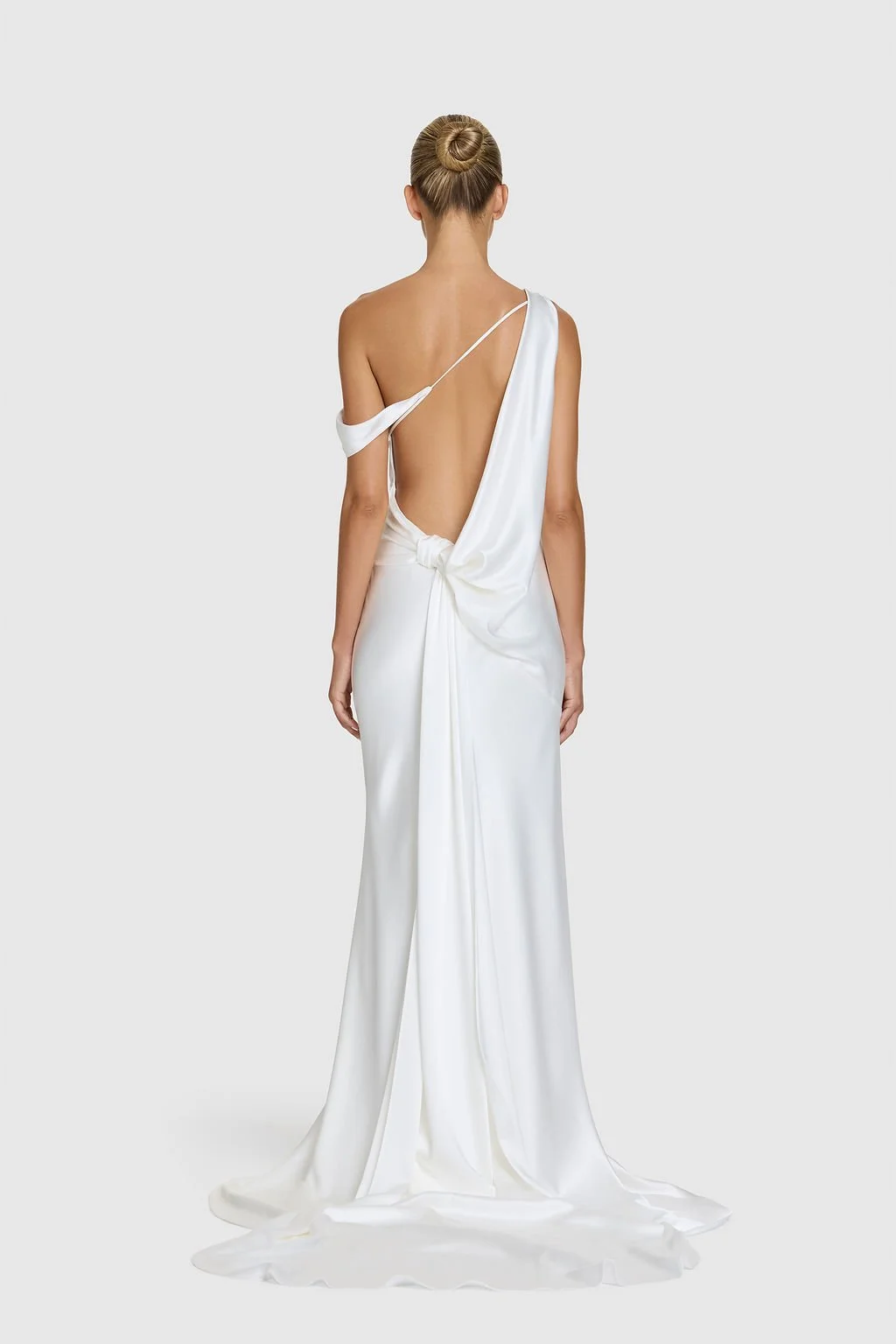 Effortlessness takes the lead in KYHA Bride Arlo. Cut on the bias, liquid double satin falls naturally over the body, delivering nonchalant energy with a distinctly modern edge. A clean, minimal off-shoulder front allows the open back to take centre 