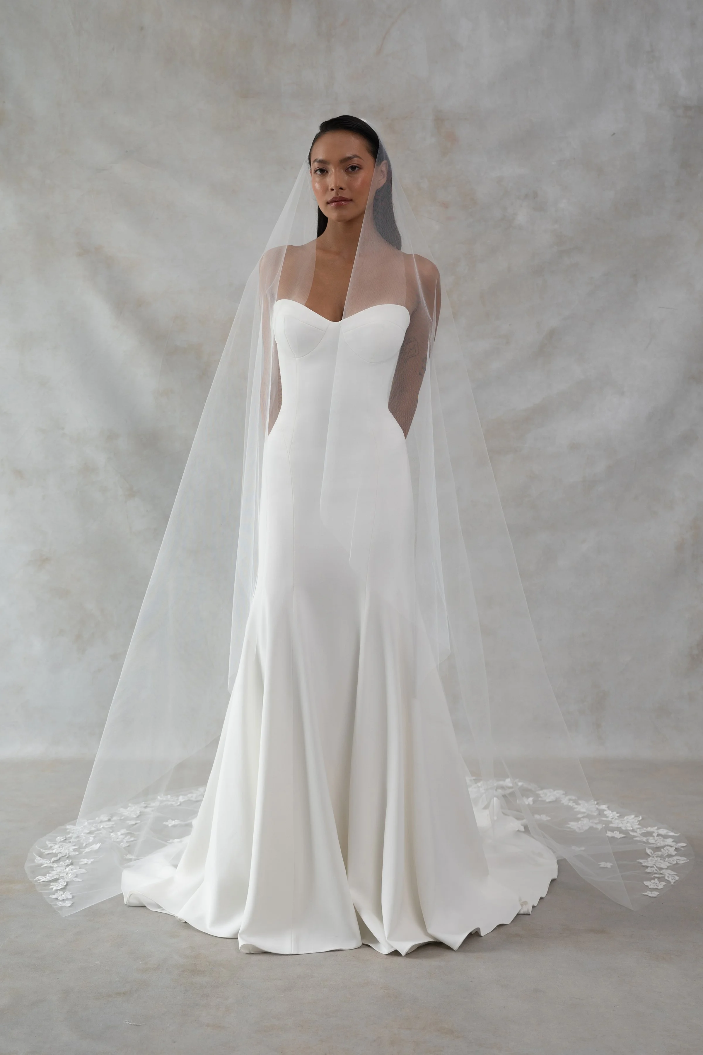 The Jenny Yoo Bridal Geeta gown is a classic bombshell. Cut in our favorite body-hugging Italian crepe, she features curve enhancing seam details and a structured bustier bodice.