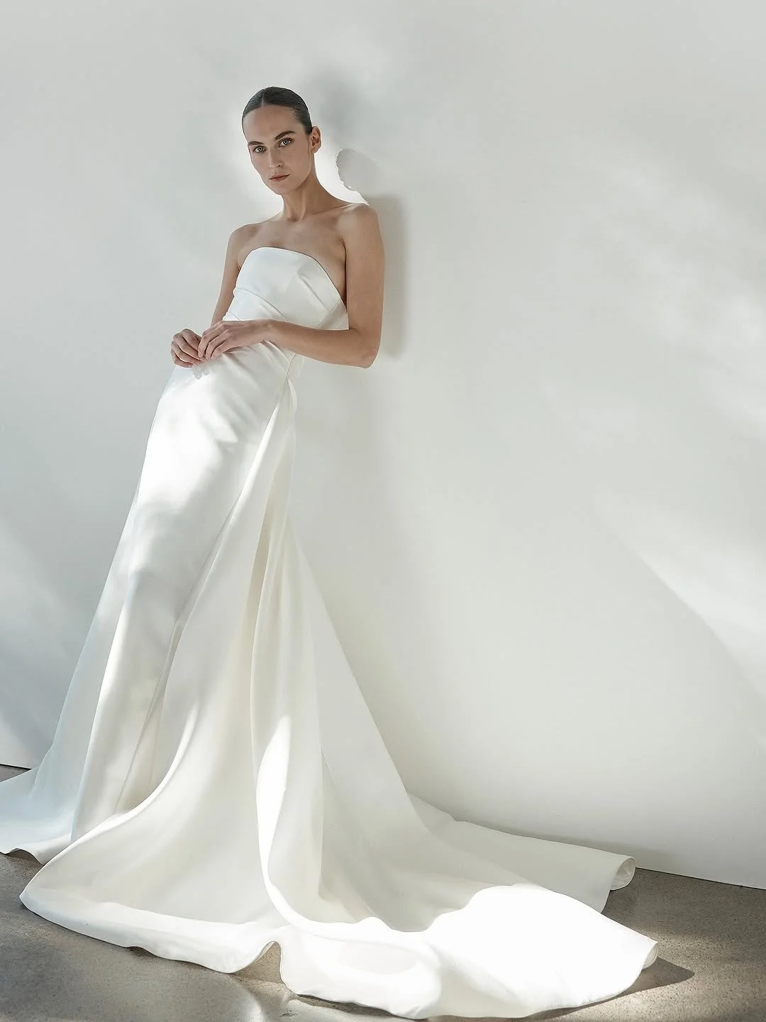 DETAILS - fit check with KYHA bride Ellery? expect minimalism with maximum impact. Ellery delivers a flawless fit thanks to its highly structured bodice, a deliberate contrast to its pared back, straight neckline and effortless drape detail. crafted 
