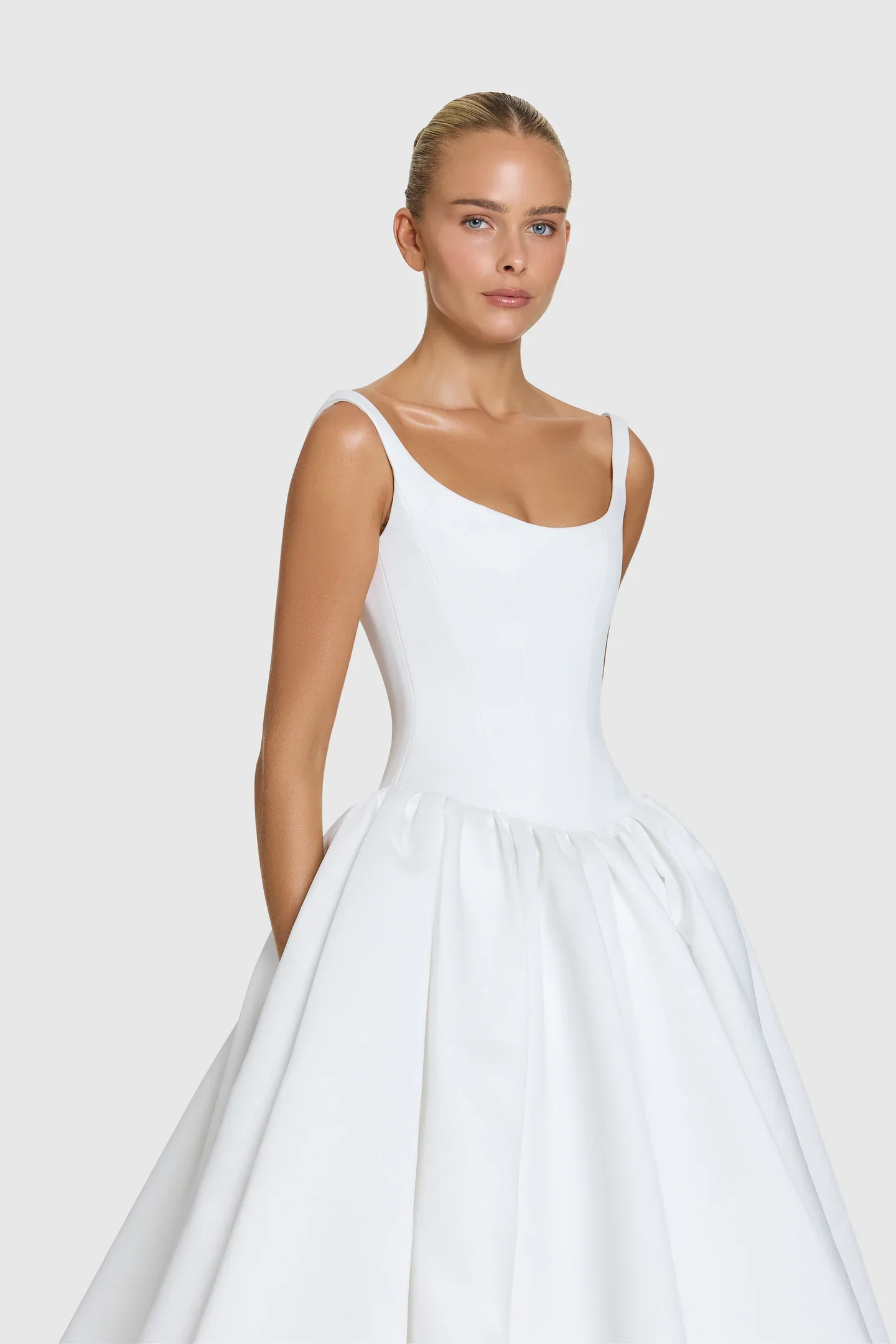 You’re a powerful presence in KYHA Bride Emery. A fresh take of a timeless silhouette, Emery balances sculpted precision with cloud-like airiness. A scoop-neck, corseted bodice flows into a gathered skirt, embodying KYHA’s signature play on structure