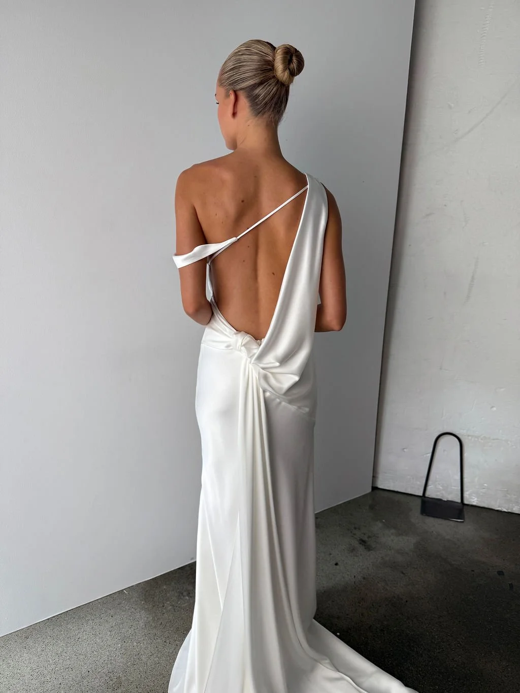 Effortlessness takes the lead in KYHA Bride Arlo. Cut on the bias, liquid double satin falls naturally over the body, delivering nonchalant energy with a distinctly modern edge. A clean, minimal off-shoulder front allows the open back to take centre 