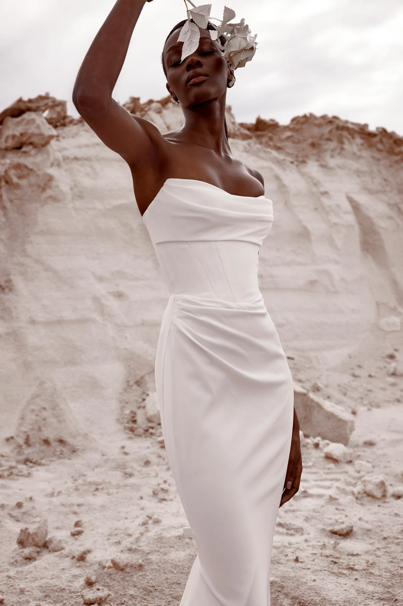 Fit for royalty, KYHA Bride Duke sees contemporary couture meet sumptuous minimalism. Its structured, corseted bodice and fit and flare skirt cuts a statuesque figure. Cut from luxe triacetate and draped artfully across its scooped neckline and waist