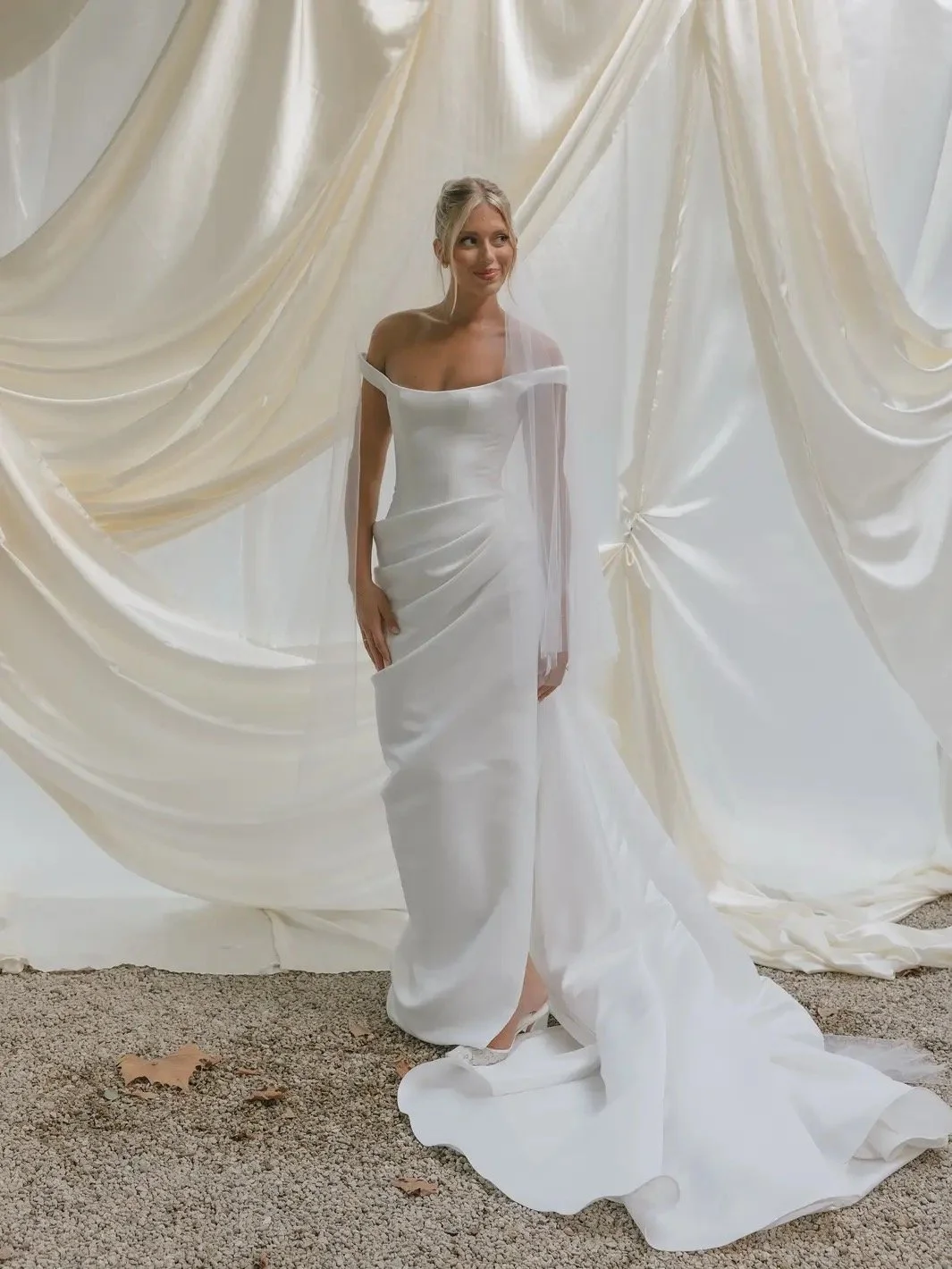 KYHA Bride Winton Gown is a modern bridal statement defined by clean lines and confident structure. featuring a sleek silhouette that skims the body, the Winton balances minimalist design with considered detailing for a refined, fashion-forward look.