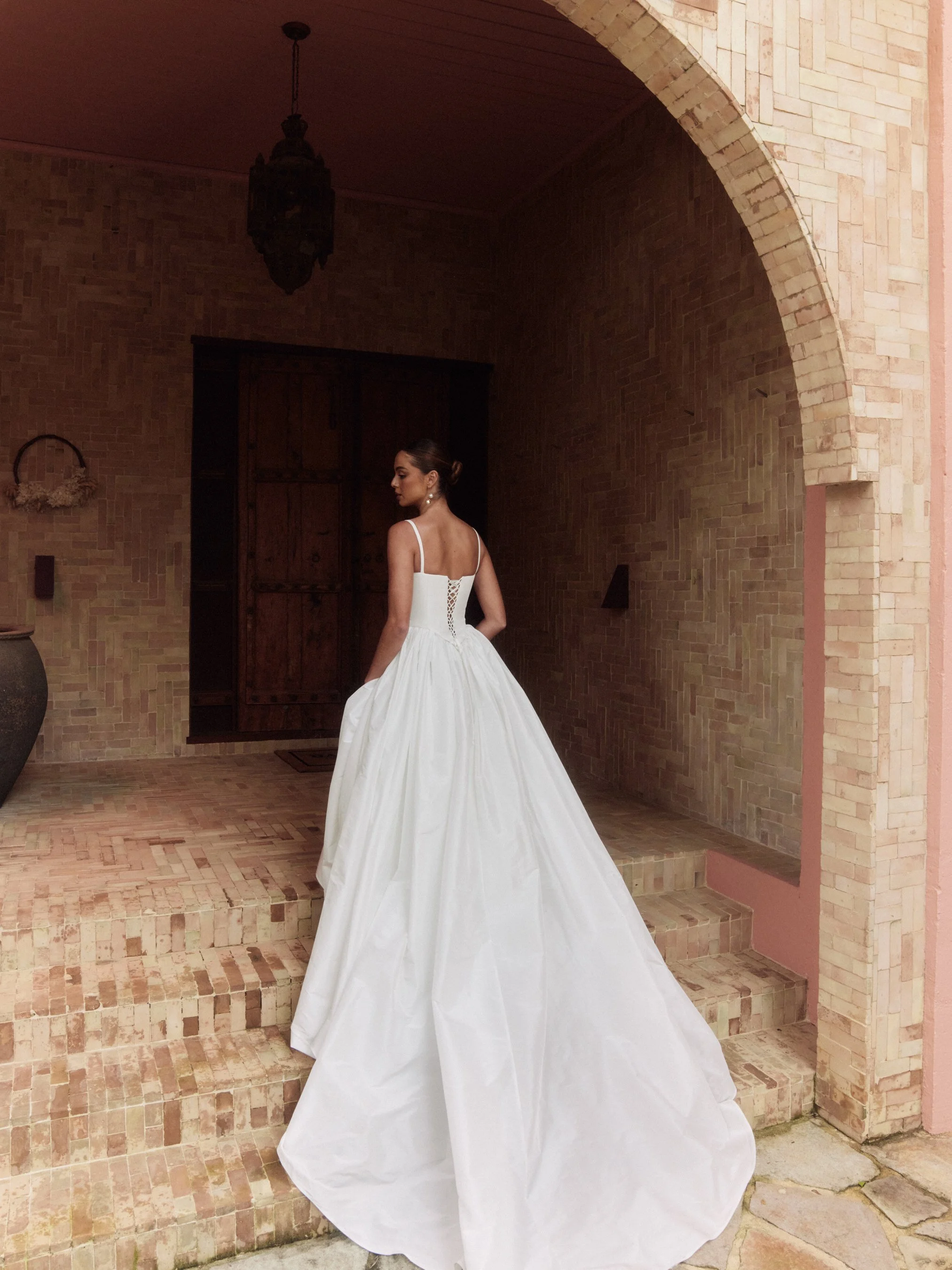 The Alena Leena Bridal protea gown: The basque corset cinches at the waist, creating that coveted hourglass shape that's so in right now. With its soft square neckline, this gown brings a fresh, modern vibe to traditional elegance. Plus, our heavily 