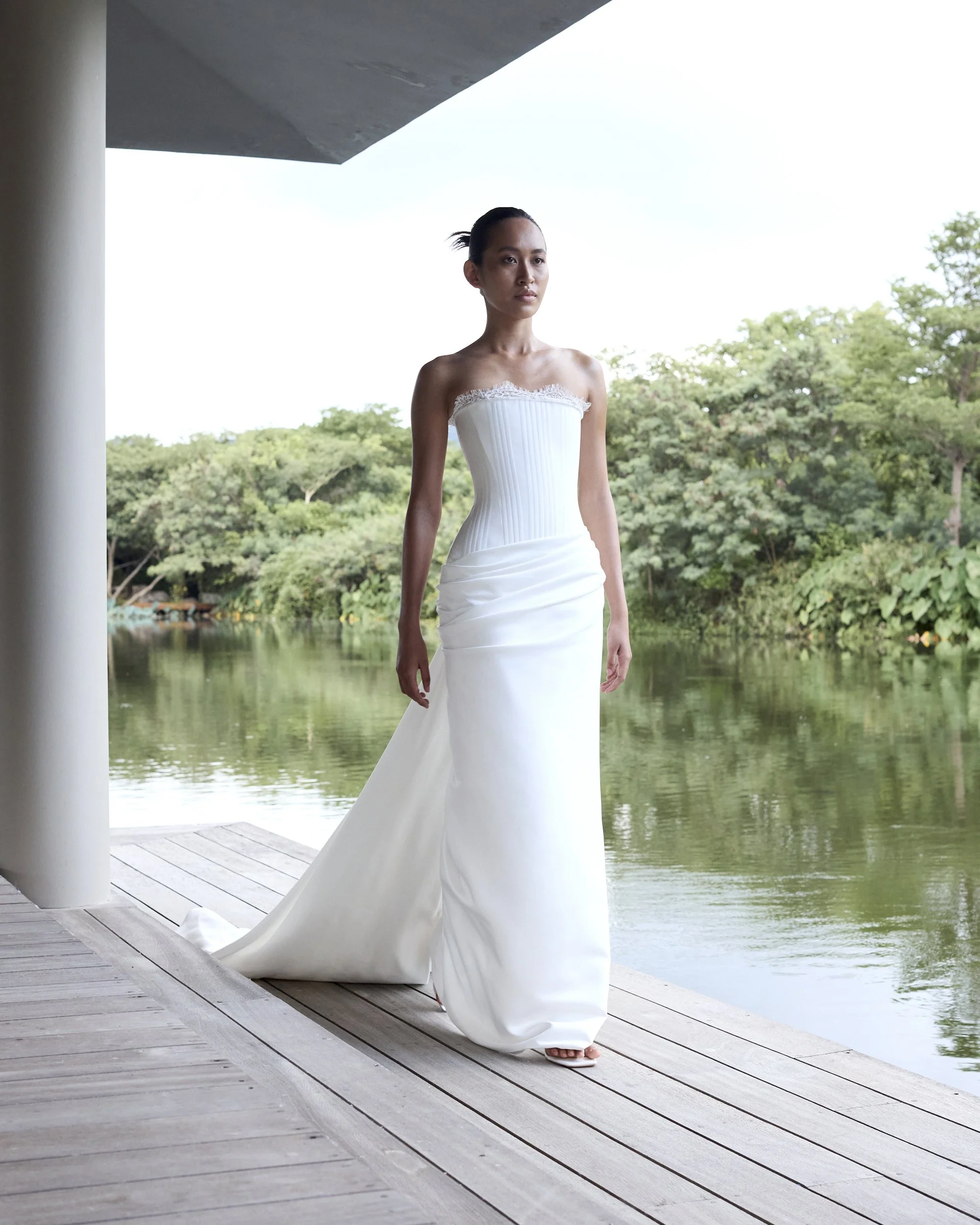 Celebrate the finer things in KYHA Bride Eaton. A structured drop waist bodice reveals fine details in a soft lace trim at the neckline and boning channels designed to draw in the eye. An asymmetric drape sweeps across the hip into a fluid column ski