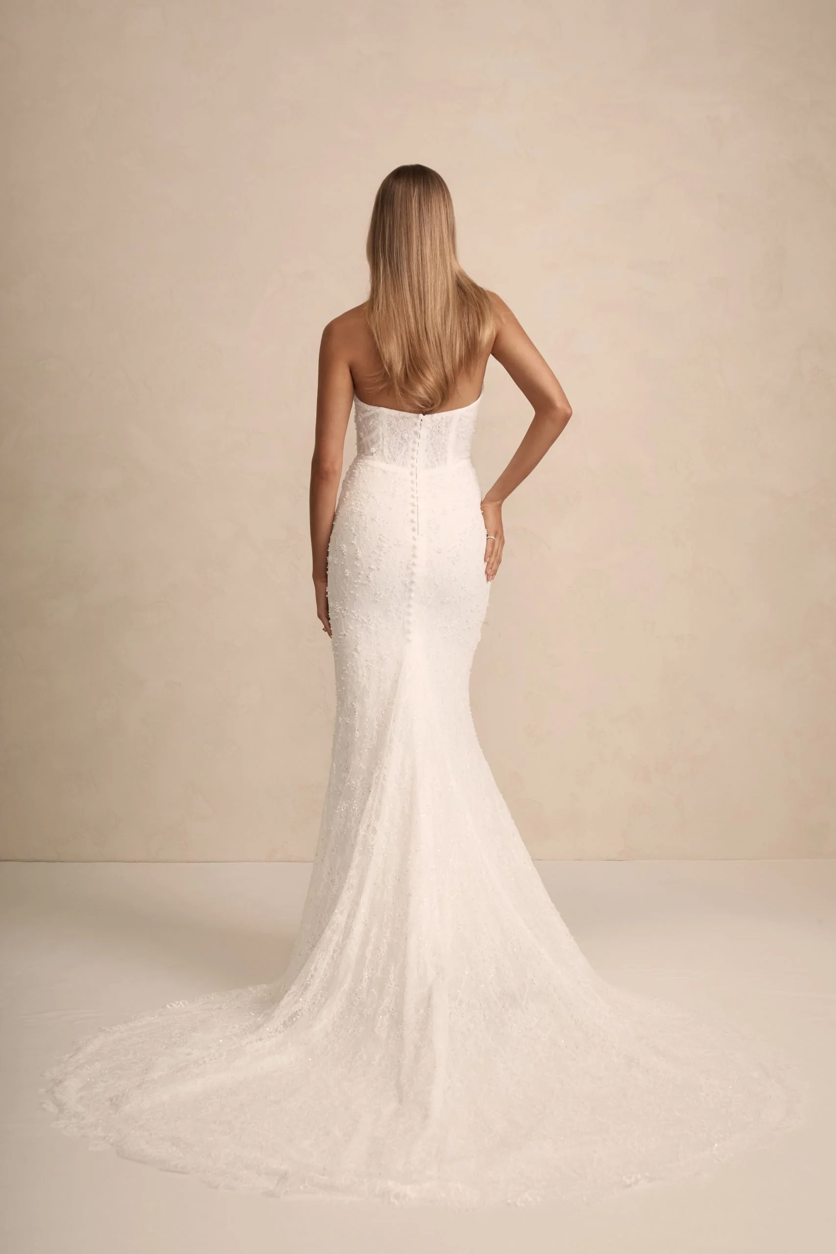 MWL Haven is made from the finest beaded Chantilly lace, with intricate eyelash lace trim details adorning the hem, adding a touch of elegance to her timeless design. Her corset back, complete with pearl-beaded ties, offers a perfect balance of detai