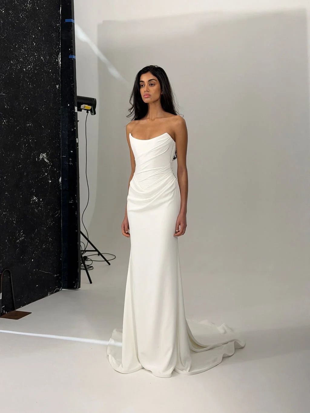 Draping becomes an art form in Archer. Crafted from a matte triacetate, a structured, scoop neckline bodice cinches the waistline and a fit and flare skirt celebrates the female form. But the star of the showstopping Archer gown is its draping. Tight