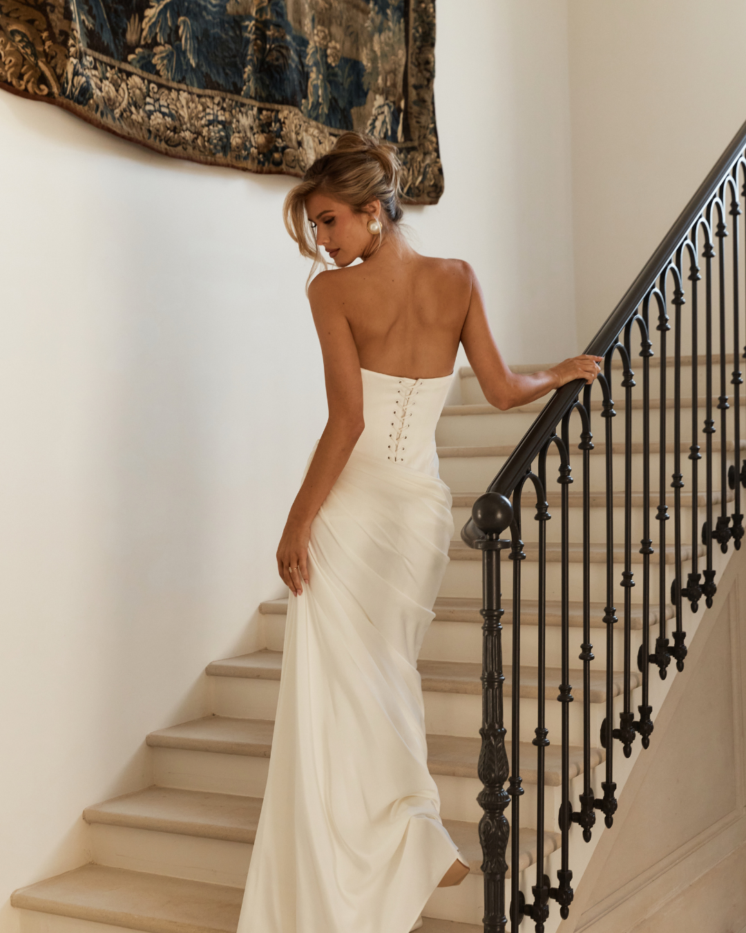 Sleek, sculptural and undeniably refined, Jane Hill Bridal Mont Blanc is designed for the bride who loves clean lines with couture-level detail. The structured bodice features subtle texturing across the bust, flowing into a dropped waist that elonga