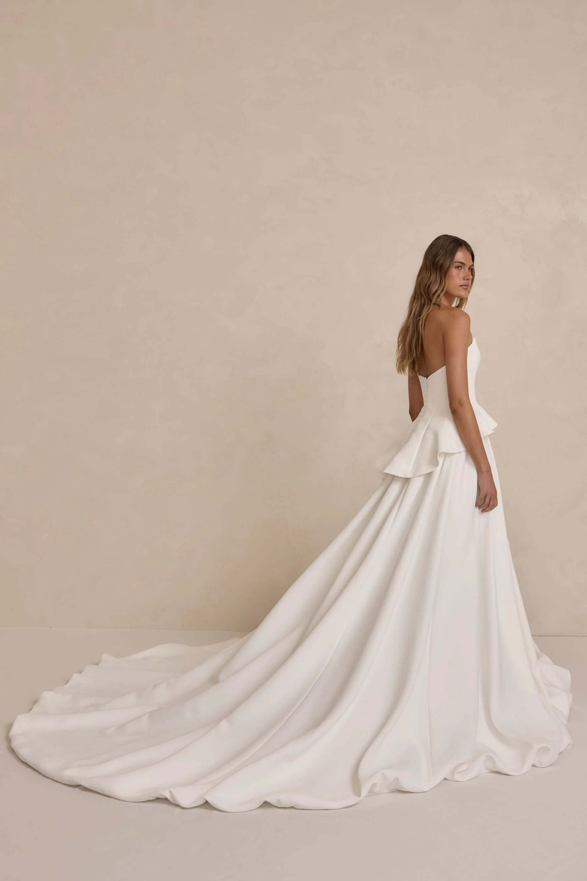 Tanner by MWL, made from our luxurious Avery Satin, the skirt flows beautifully and is finished with a bagged out bubble hem, adding subtle volume and a touch of drama. Inside the bodice, interfacing provides extra support, ensuring a secure and eleg