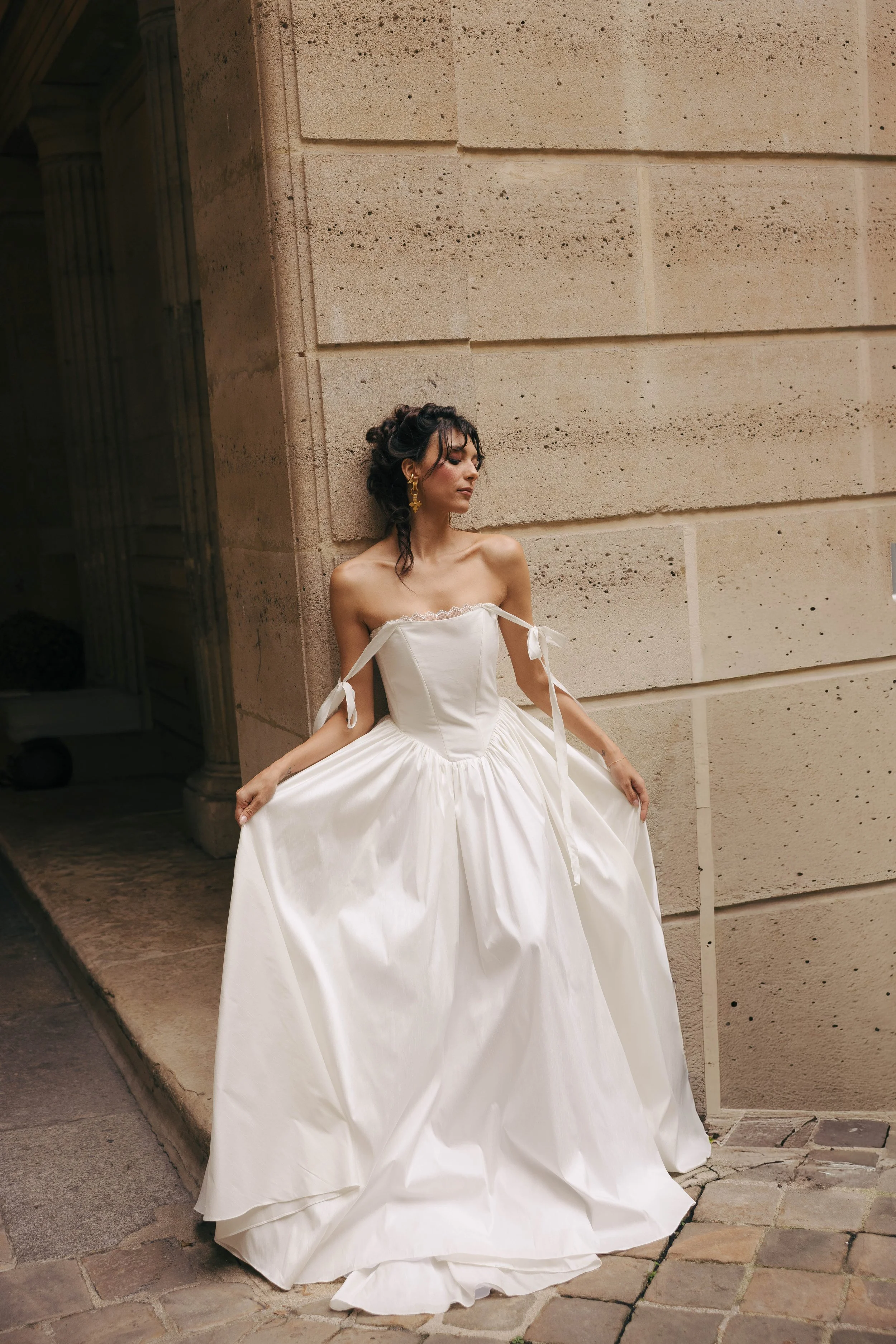 The & For Love Bridal Louis XVI gown is a striking blend of modern elegance and regal inspiration. Designed for the fashion-forward bride, this couture wedding dress features clean lines, refined structure, and a contemporary silhouette that feels bo