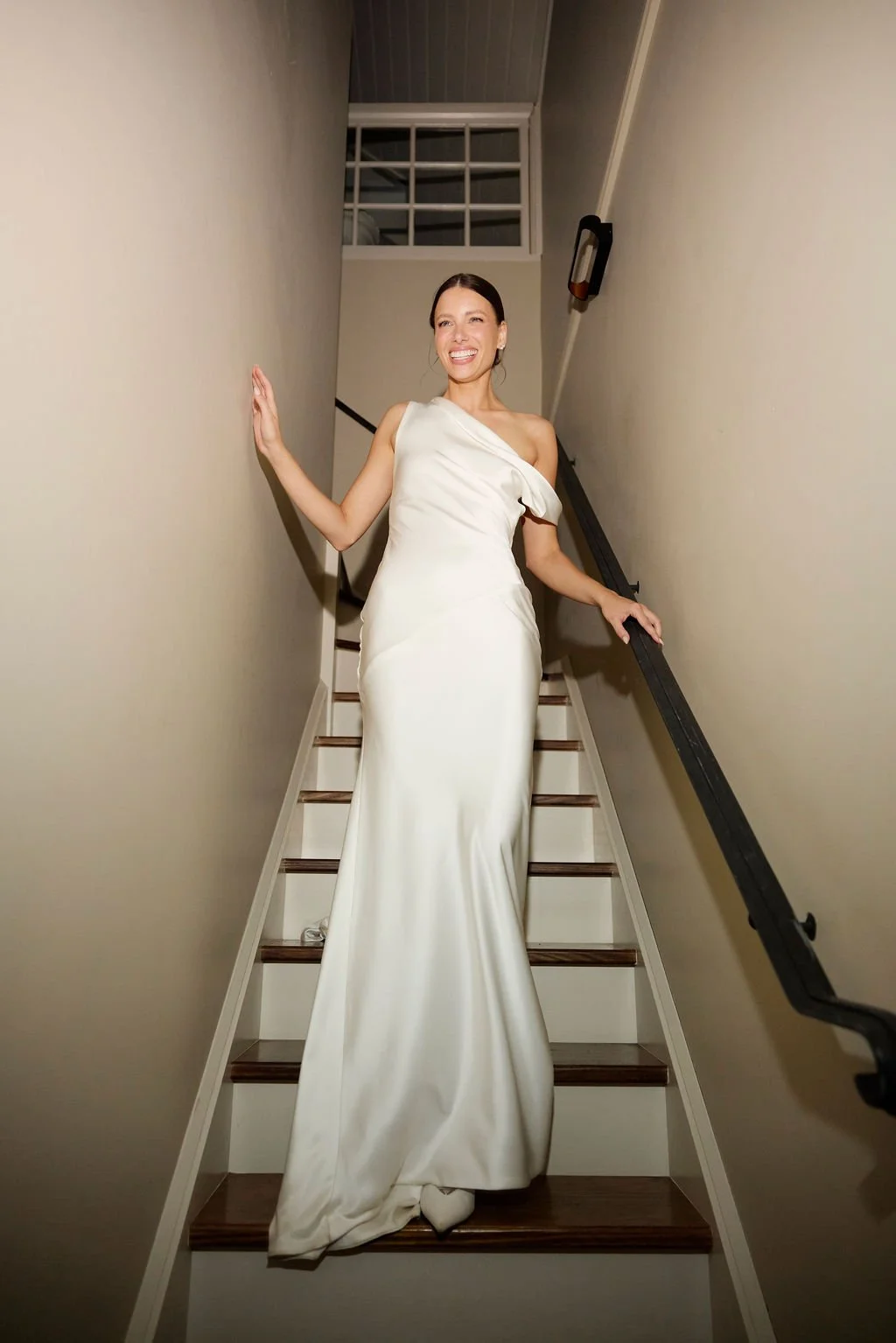 Effortlessness takes the lead in KYHA Bride Arlo. Cut on the bias, liquid double satin falls naturally over the body, delivering nonchalant energy with a distinctly modern edge. A clean, minimal off-shoulder front allows the open back to take centre 